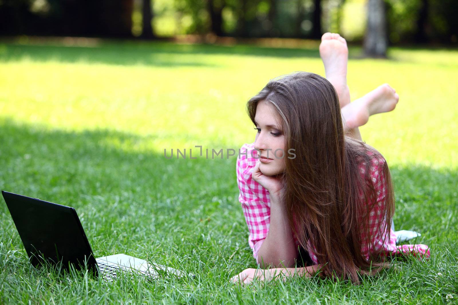 Young and beautiful woman with laptop in park