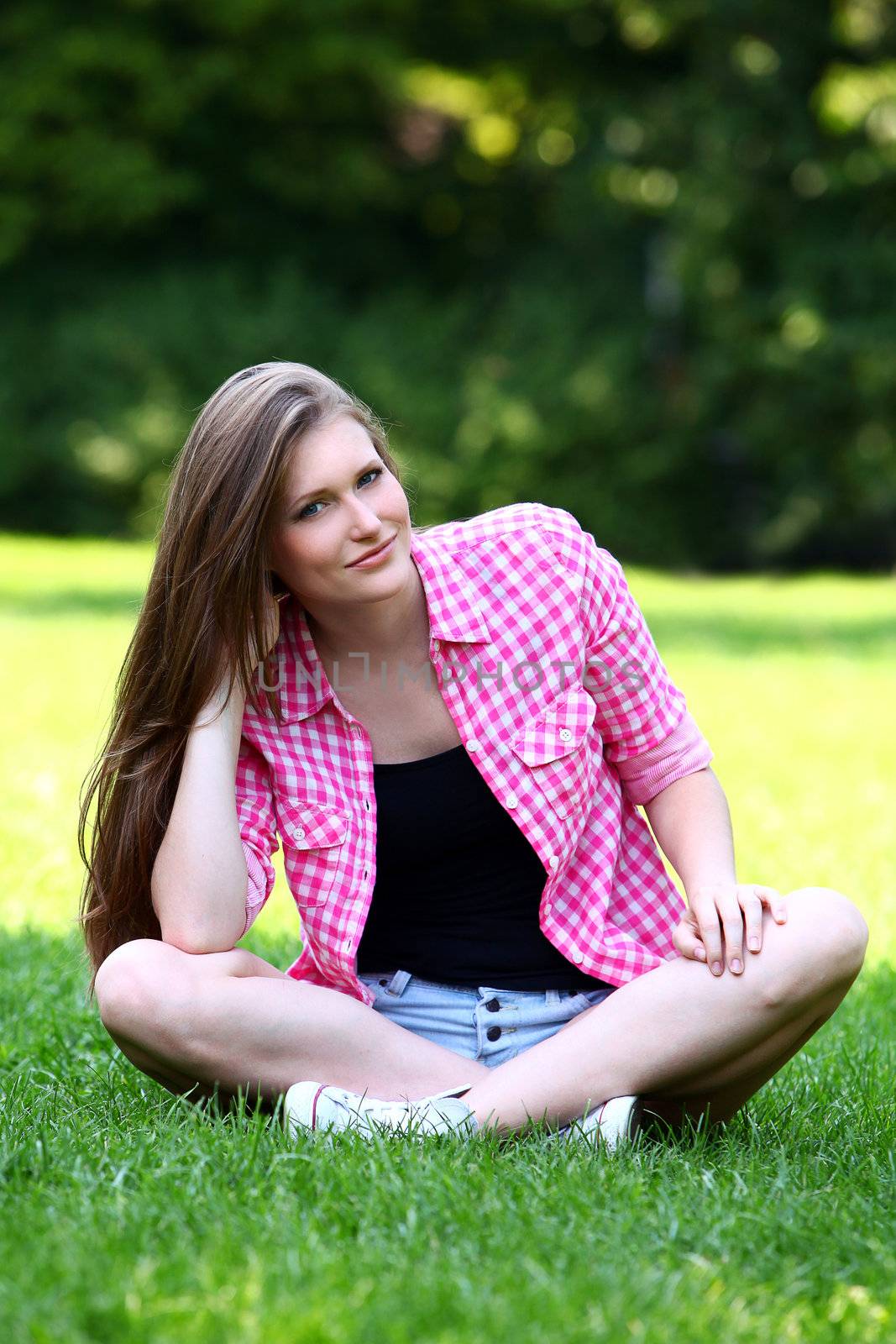 Beautiful woman with laptop in park by rufatjumali