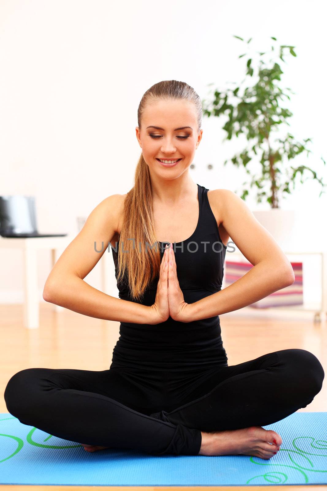 Happy and beautiful woman meditate at home by rufatjumali