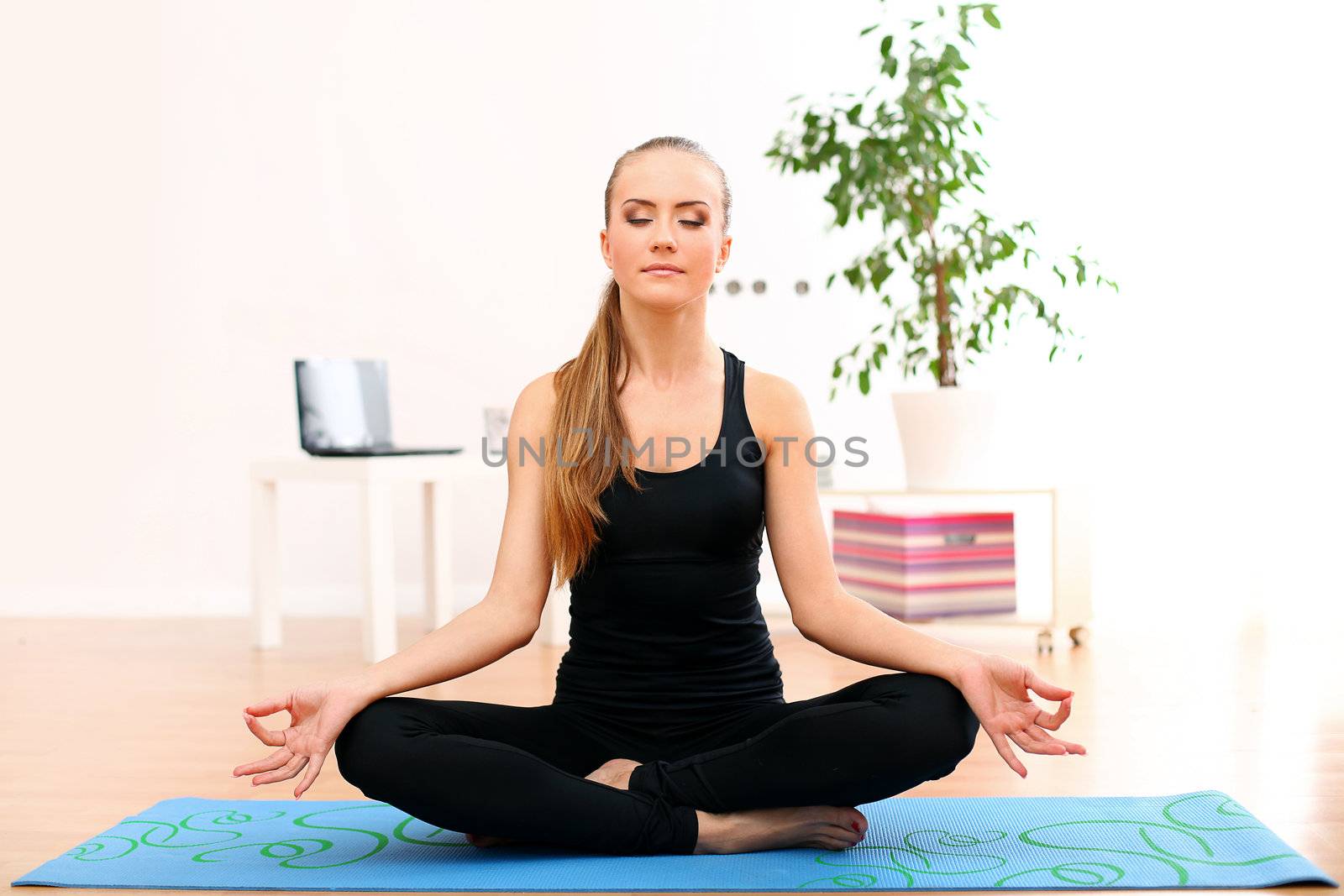 Young and beautiful woman meditate at home by rufatjumali