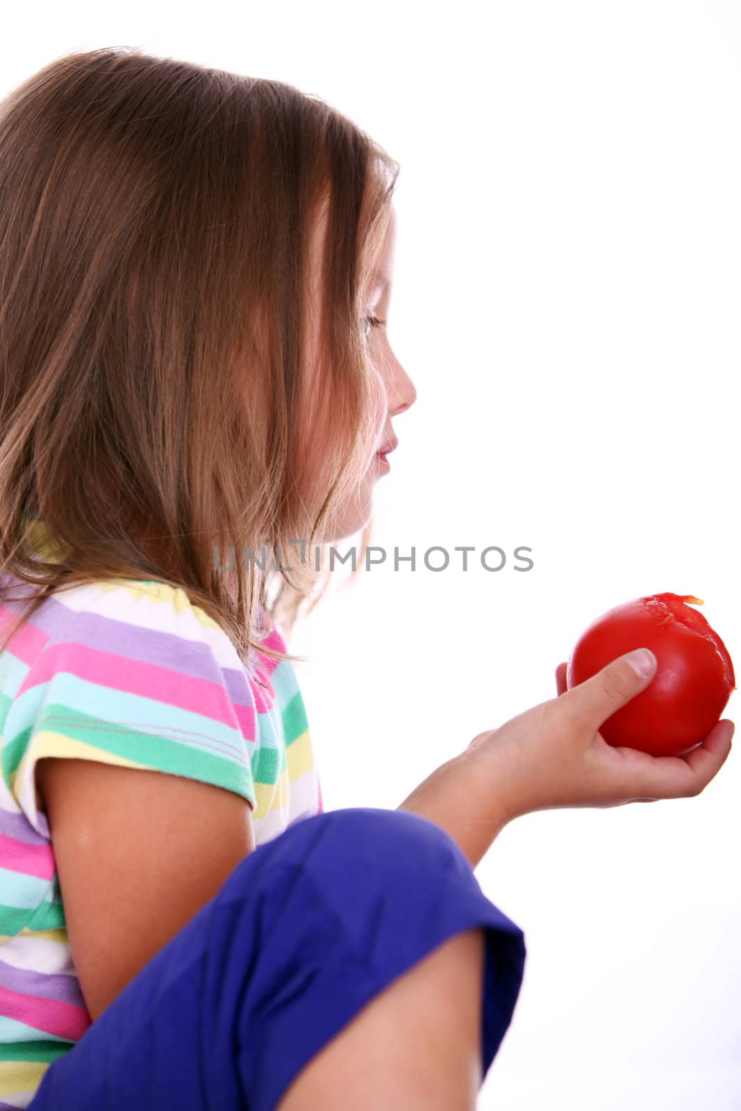 Close up of Little girl eat tomato