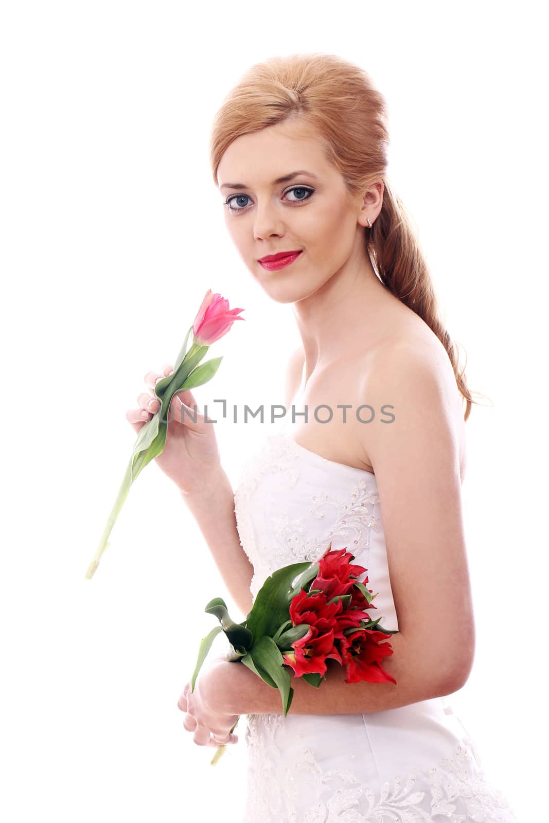 Portrait of young bride smelling red rose