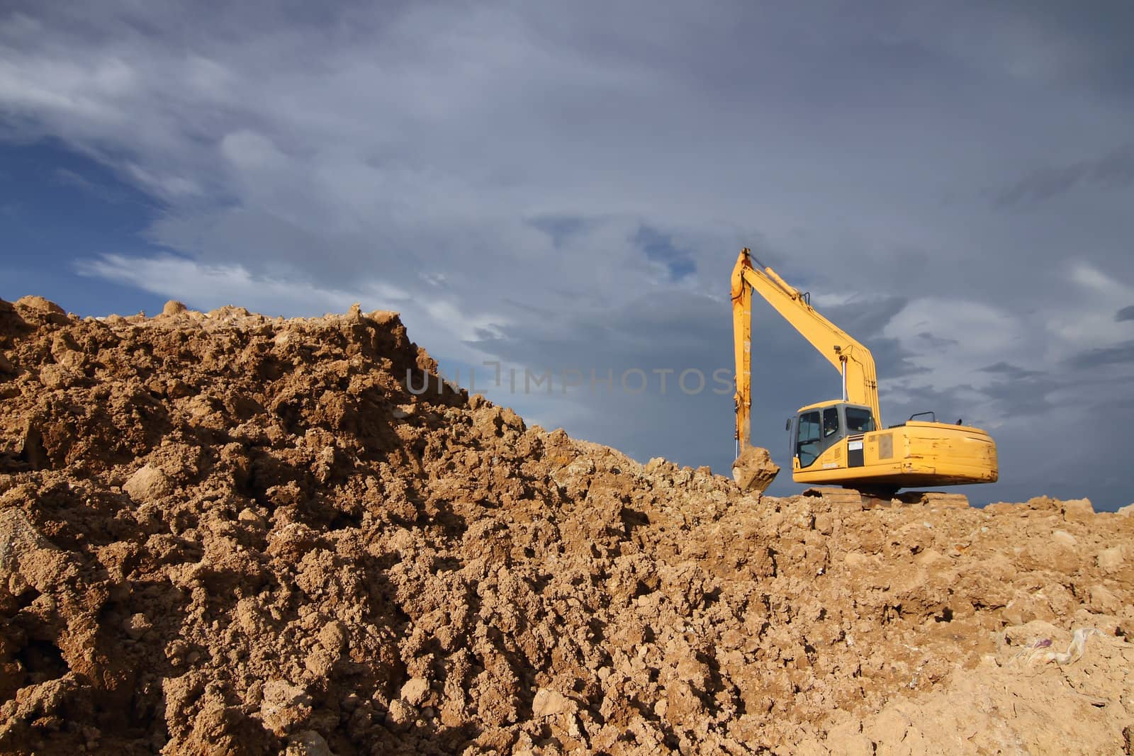 excavator loader machine during earthmoving works outdoors at construction site