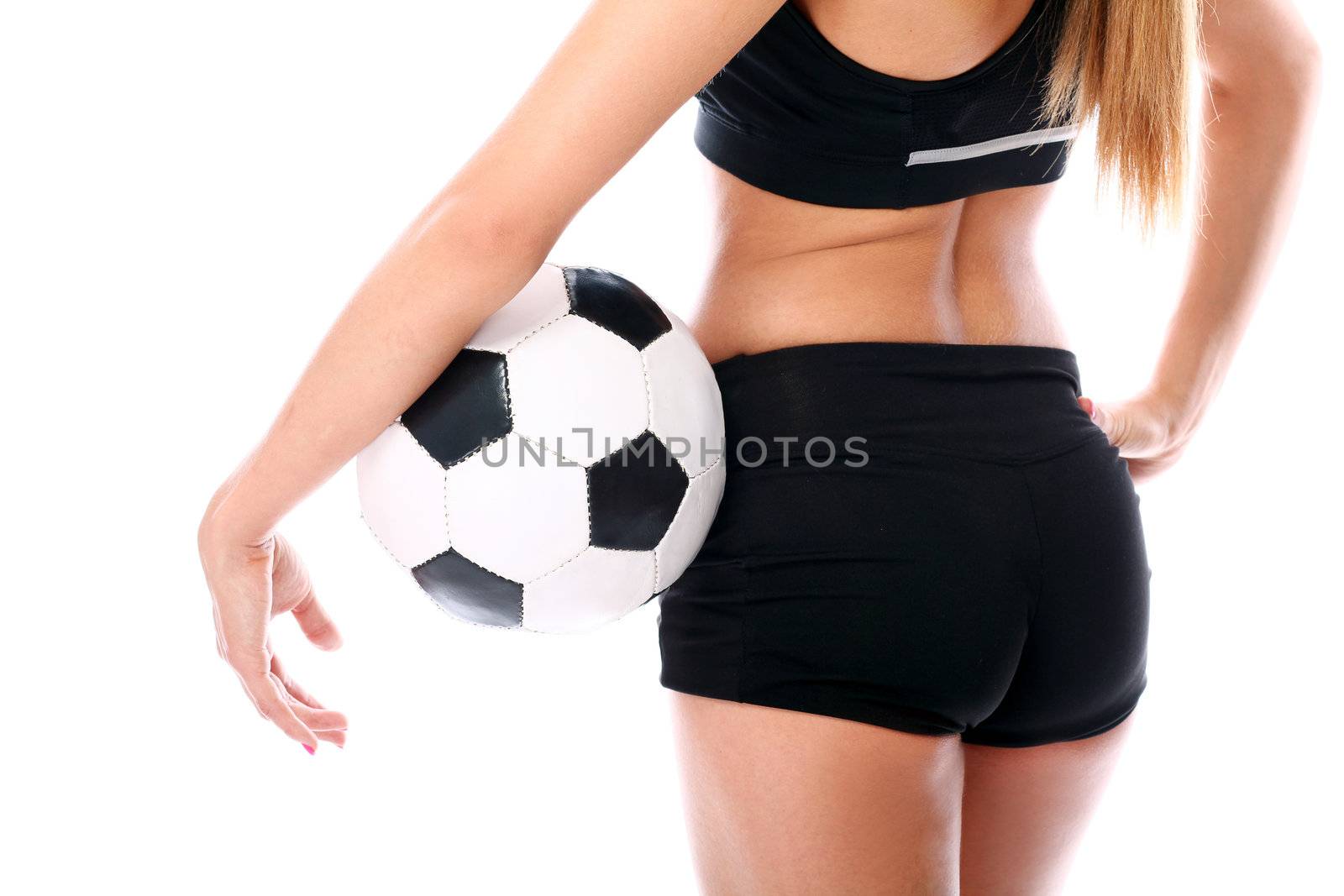 Young and sexy girl`s body with soccer ball over white background