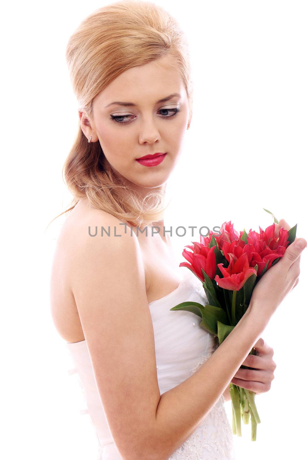 Portrait of young bride with red roses