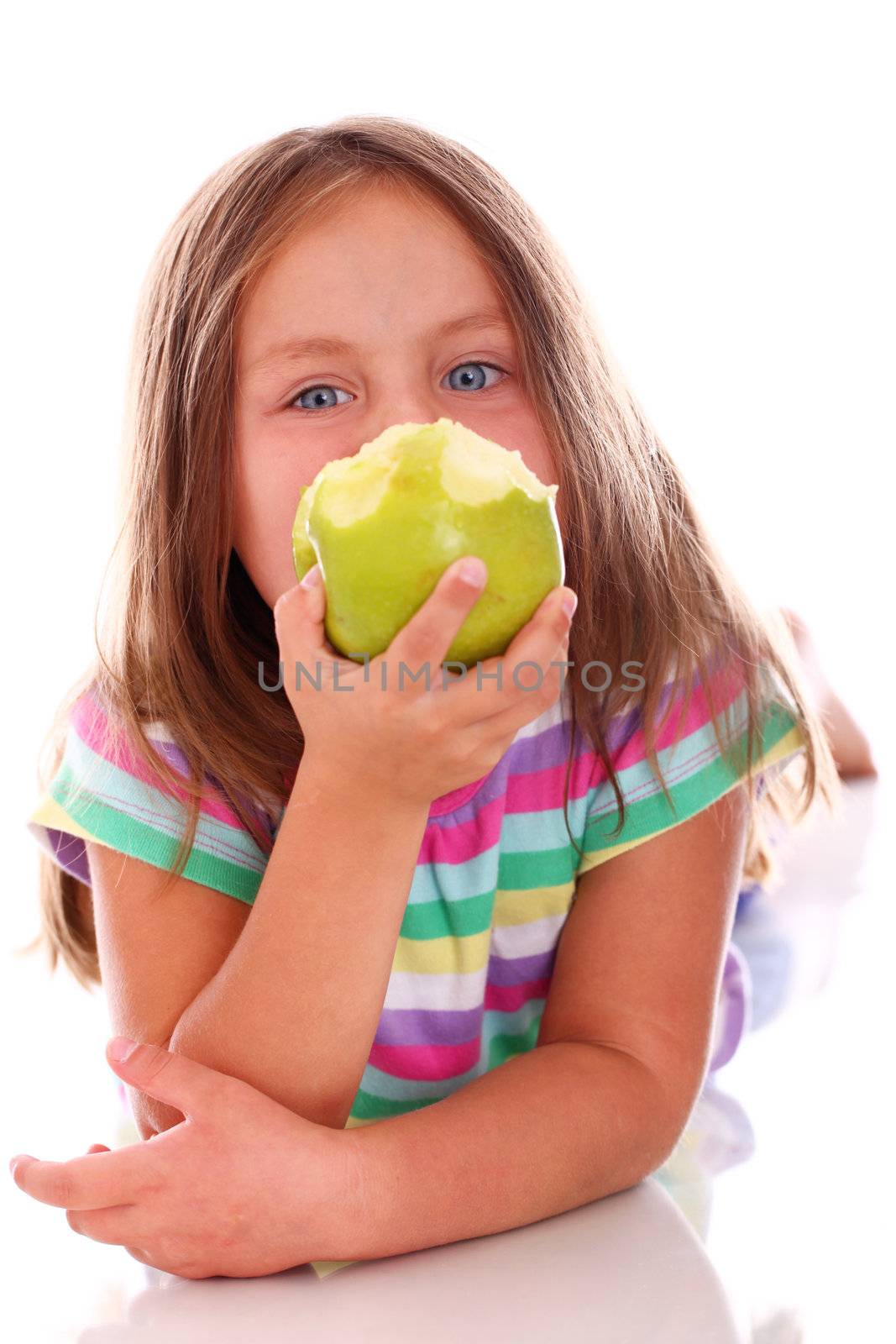 Portrait of little girl eating green apple