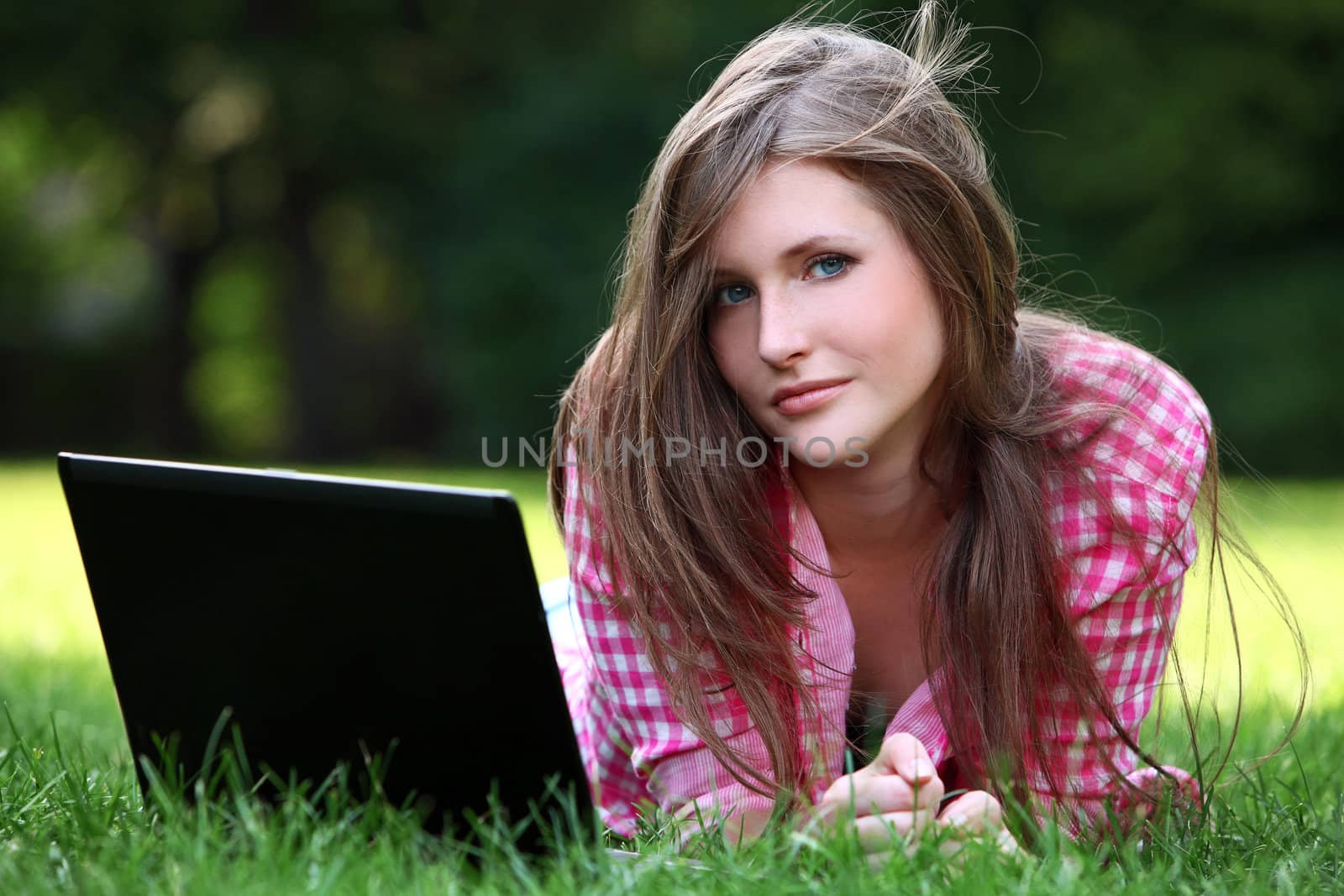 Young and beautiful woman with laptop in park