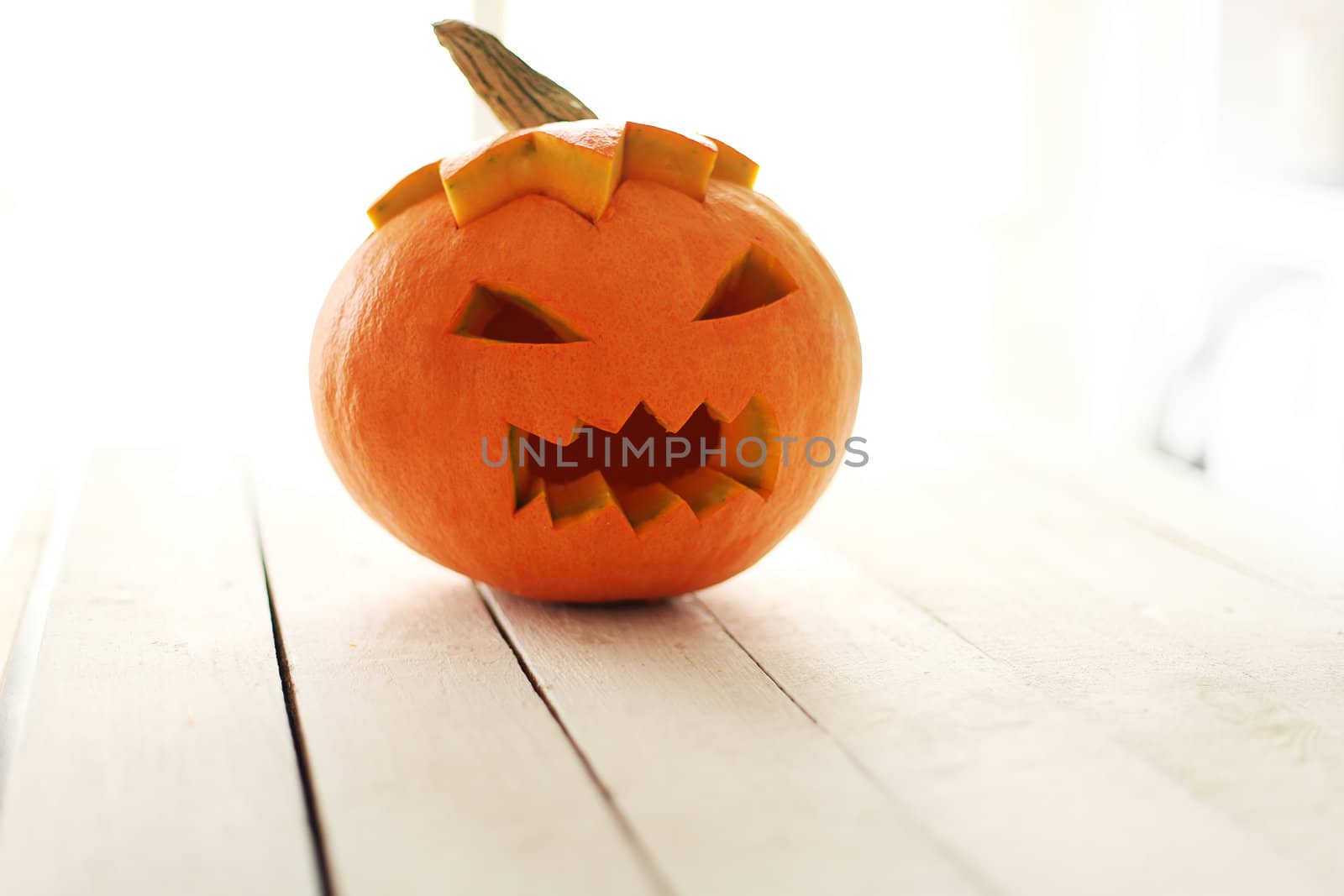 Halloween pumpkin on a white wooden surface