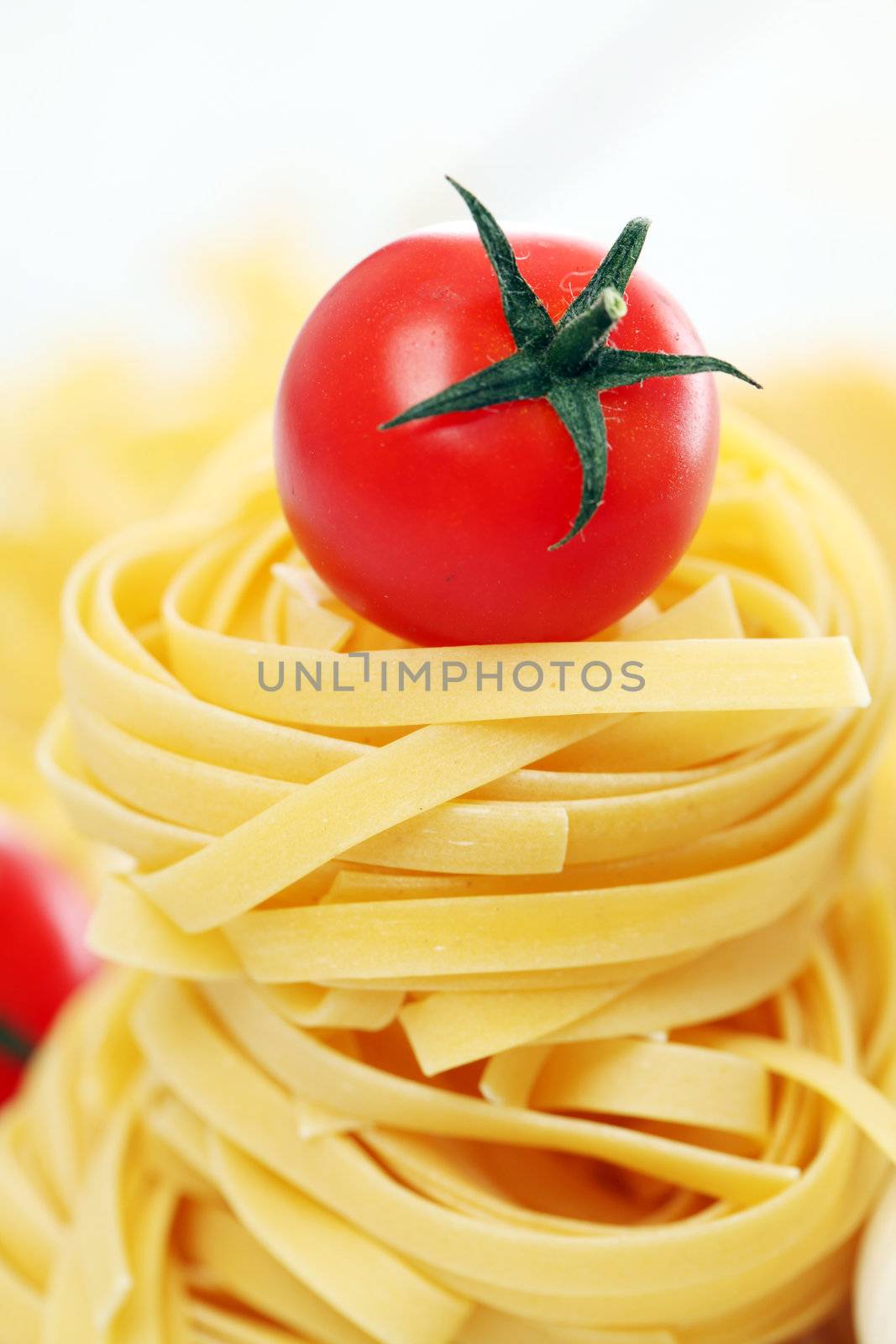 Italian pasta and cherry tomato isolated on white background