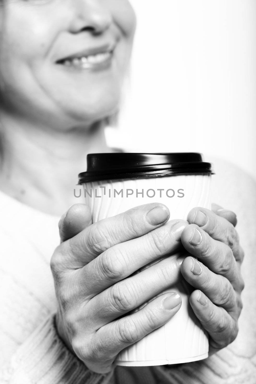 Close up of midlle aged woman with coffee by rufatjumali