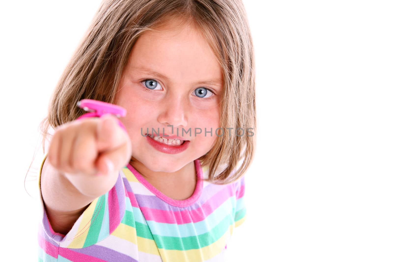 Little girl in front of white background pointing at you