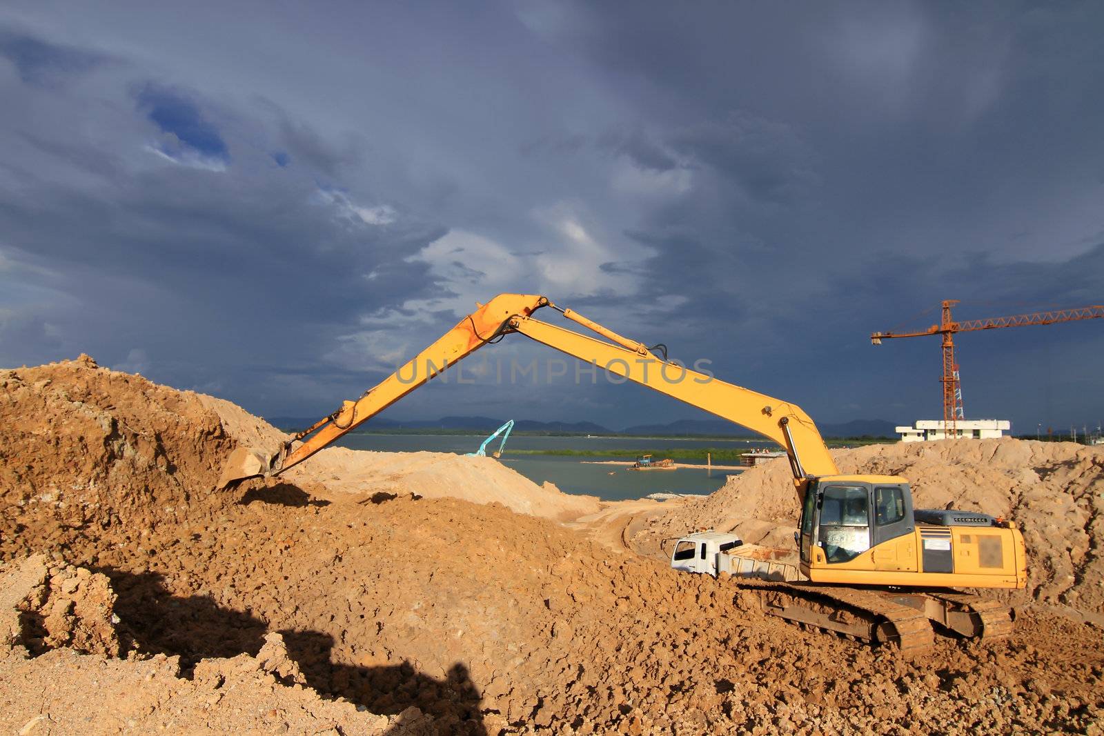excavator loader machine during earthmoving works outdoors at construction site