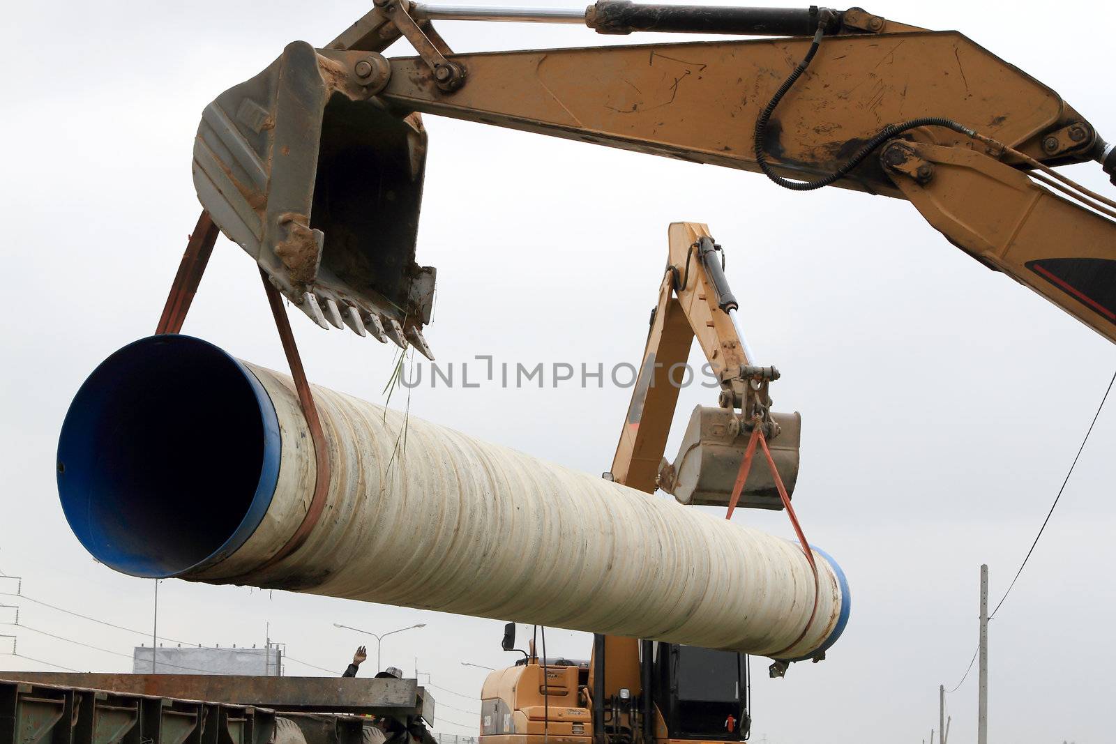 Specialized equipment for placing large diameter pipe in a trench
