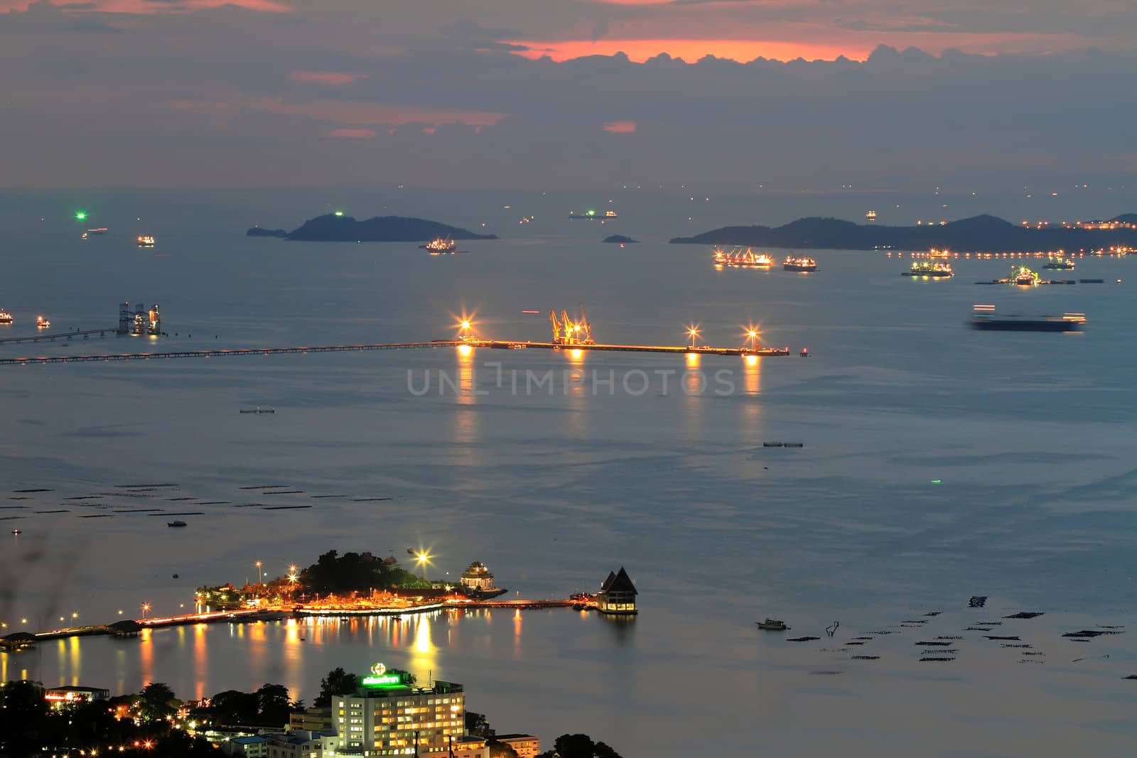 Port warehouse with cargoes and containers at night