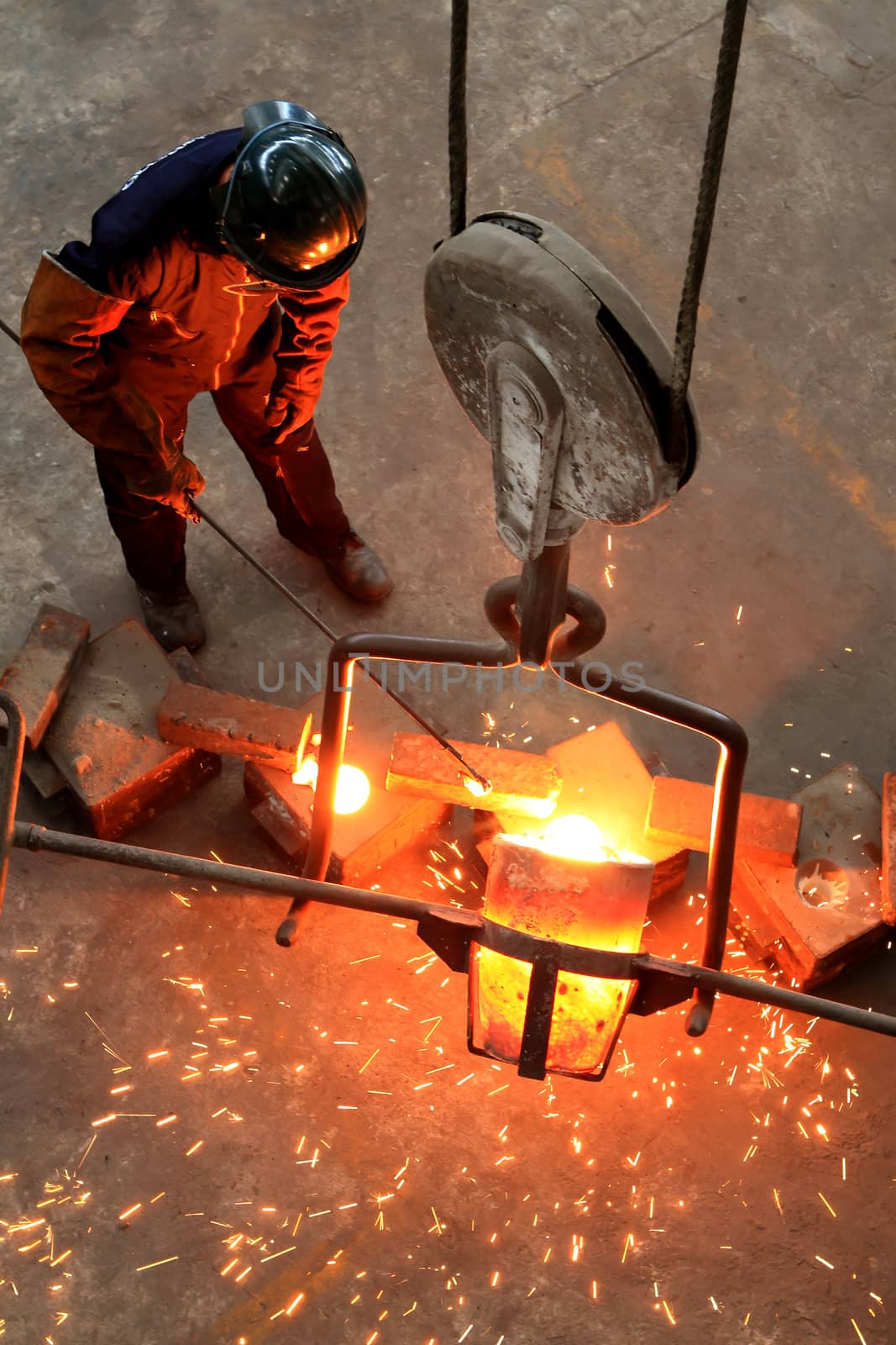 Pouring Molten Metal into Mold - focus on pour