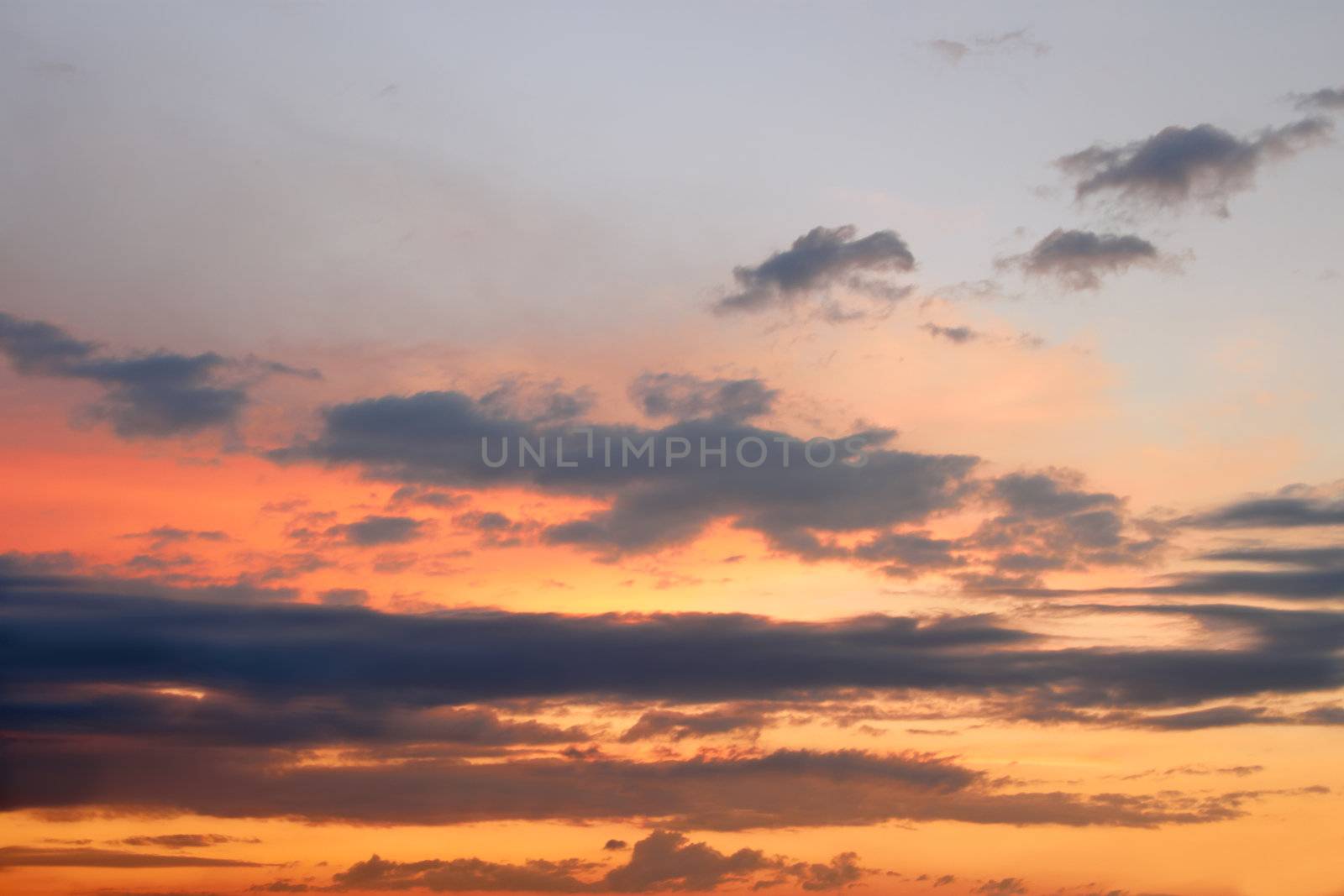 Heaven at sunset. Colorful cloudscape illuminated by the rays of setting sun