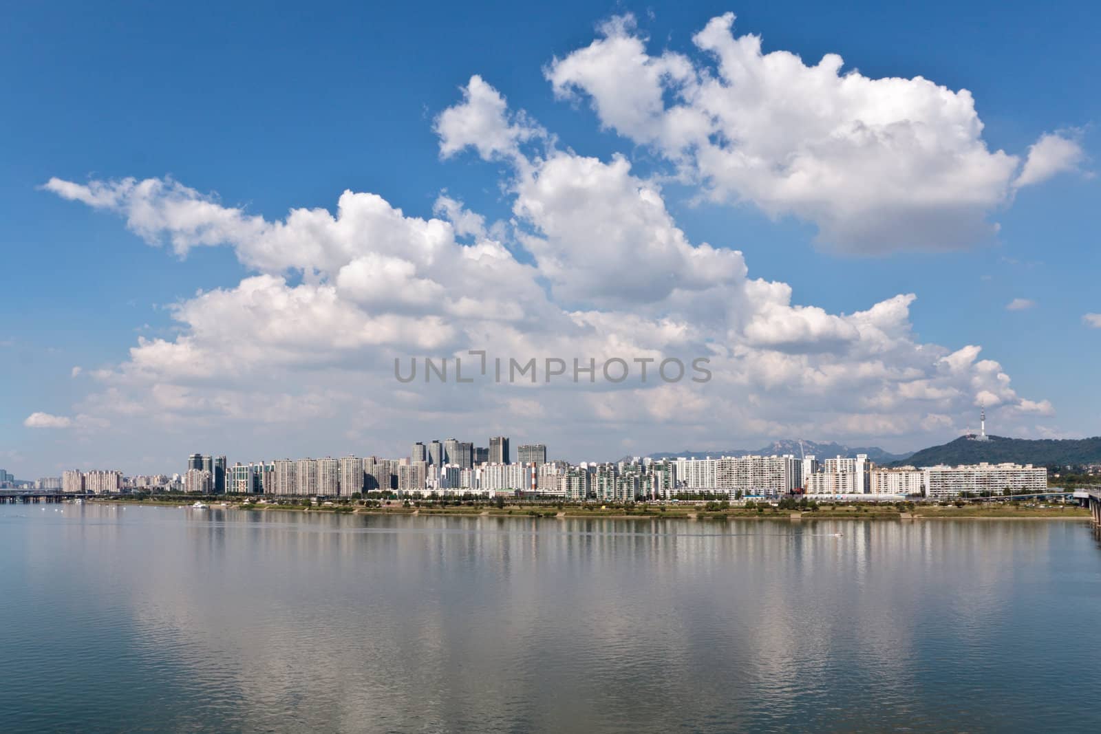 Beautiful panoramic view of a city on a river under a cloudy sky