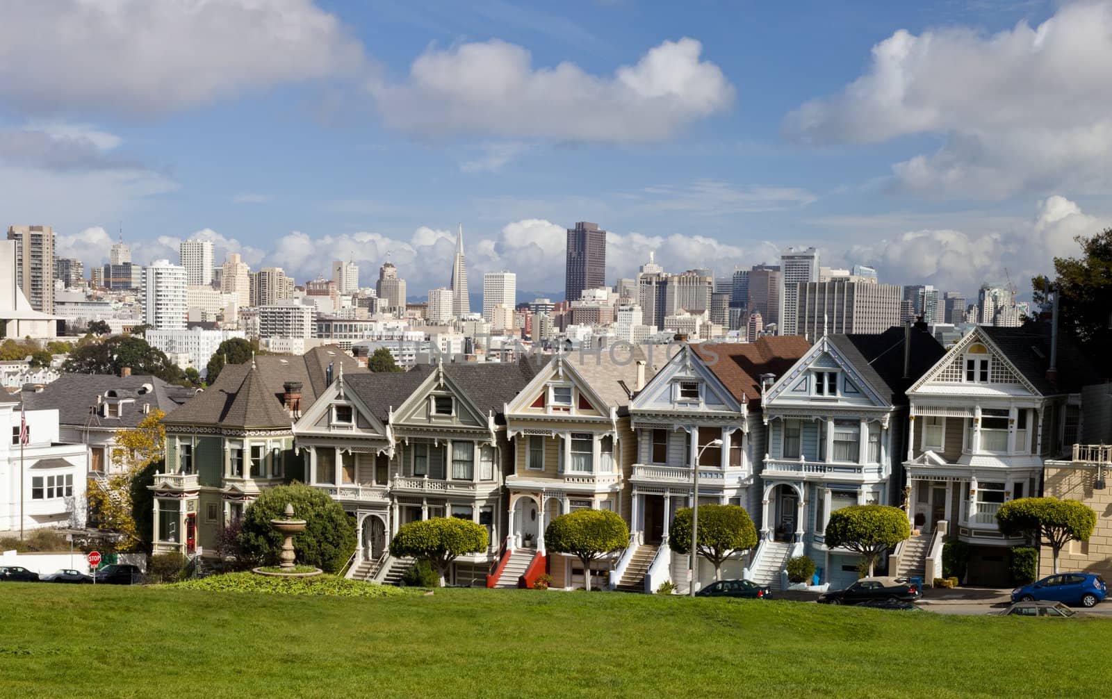 Painted Ladies with San Francisco skyline in the background as seen from Alamo Square.