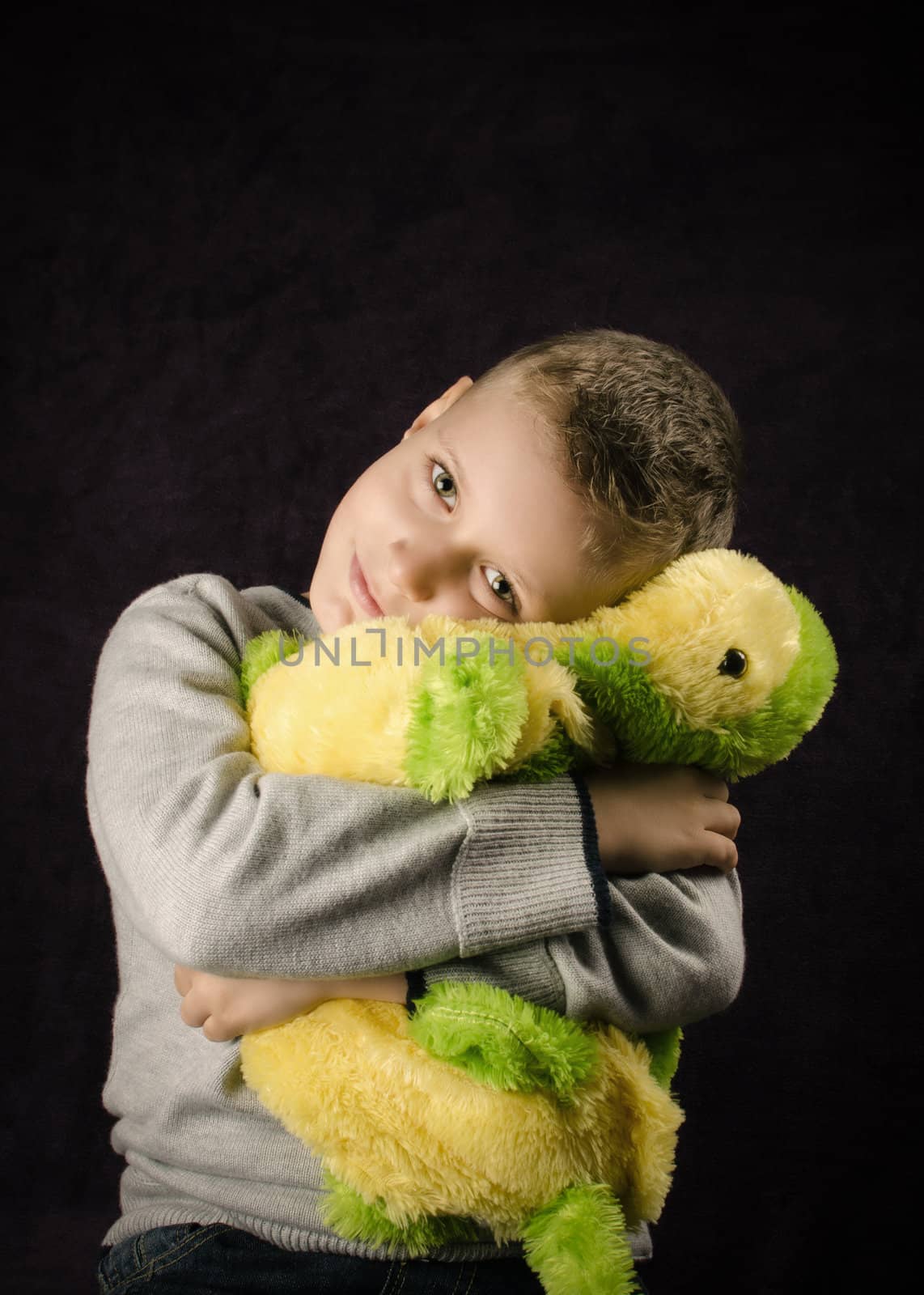 Happy little Boy hugging a toy