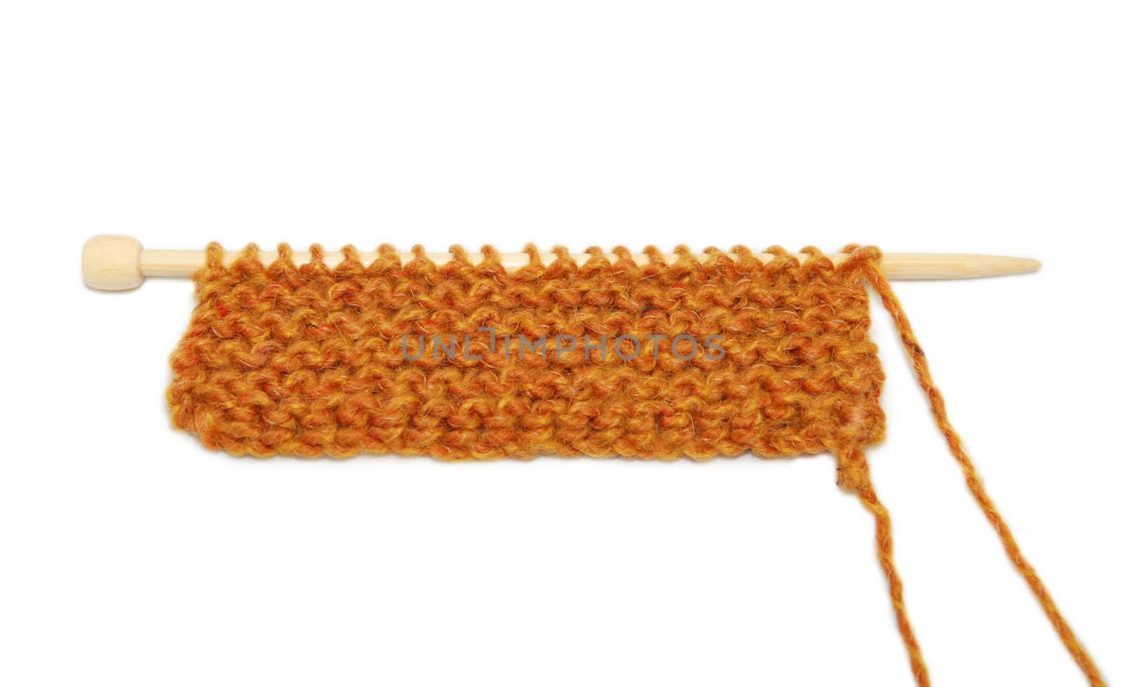 Short length of garter stitch knitting on one needle, isolated on a white background