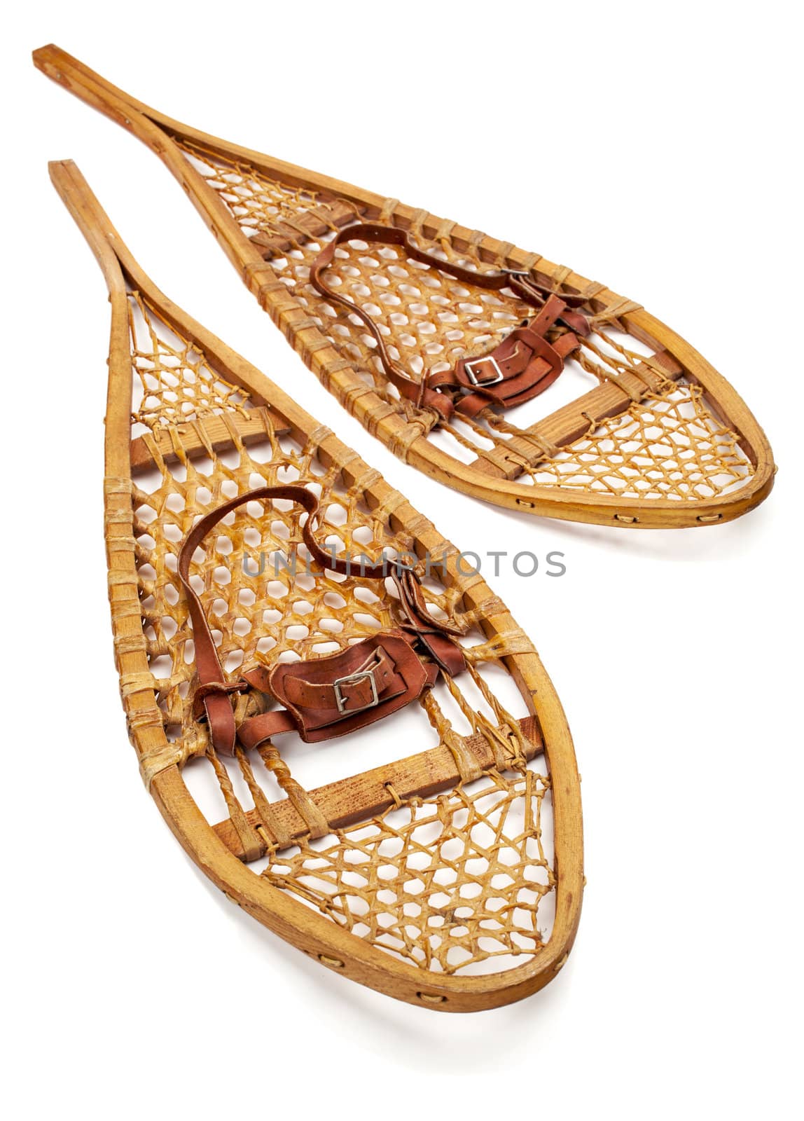 vintage wooden Huron snowshoes with leather binding on white
