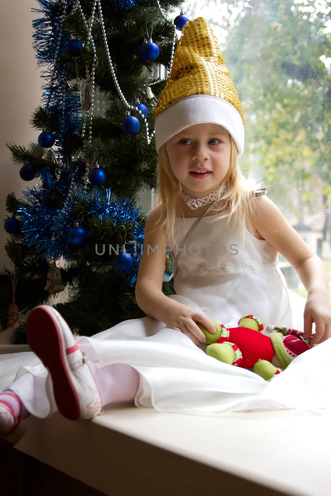 Portrait of happy girl in  Christmas tree by victosha