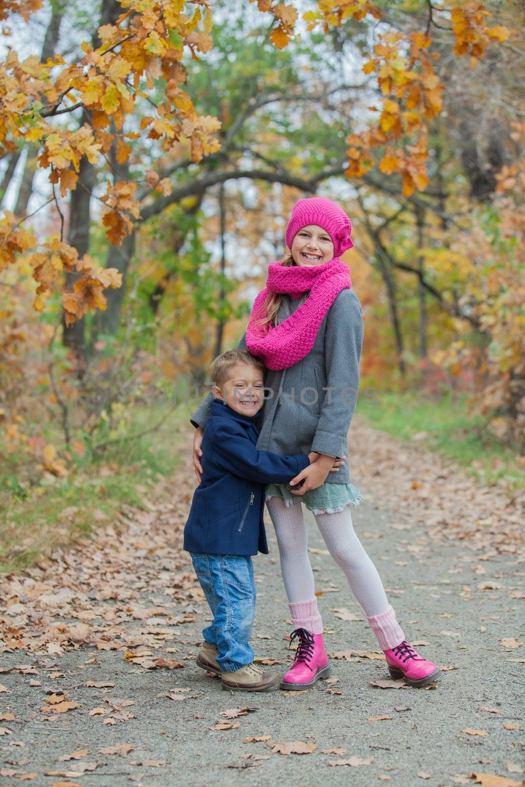 Children playing in autumn park. Kids outdoor games.