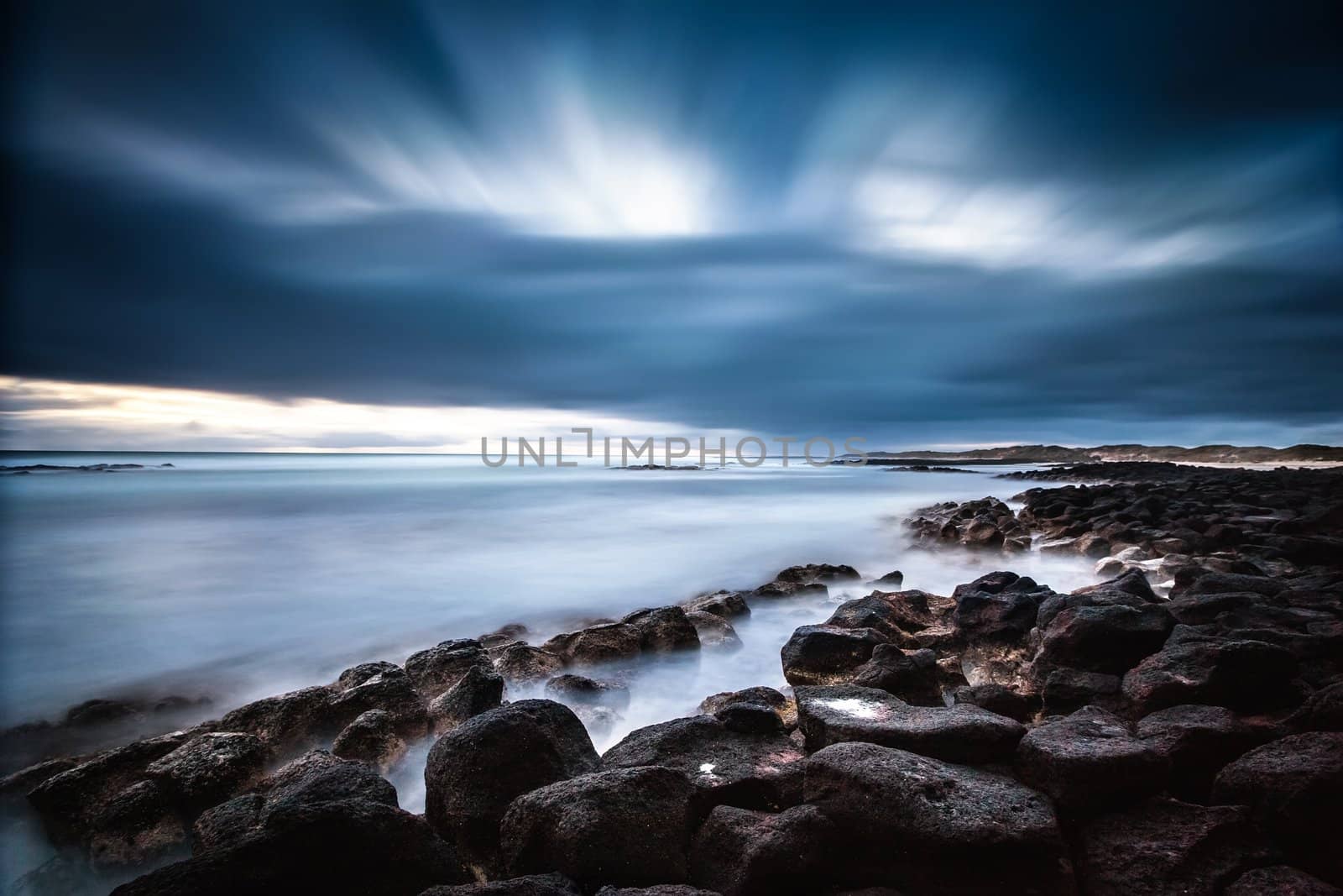 Another shot from a cold sunset shoot. Extra long exposure was used to capture the cross flowing cloud and flat sea.