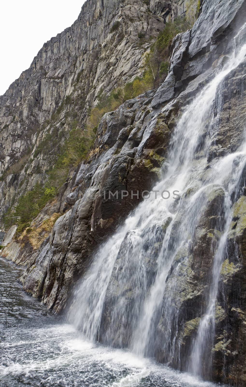 steep mountain with waterfall in norway, europe