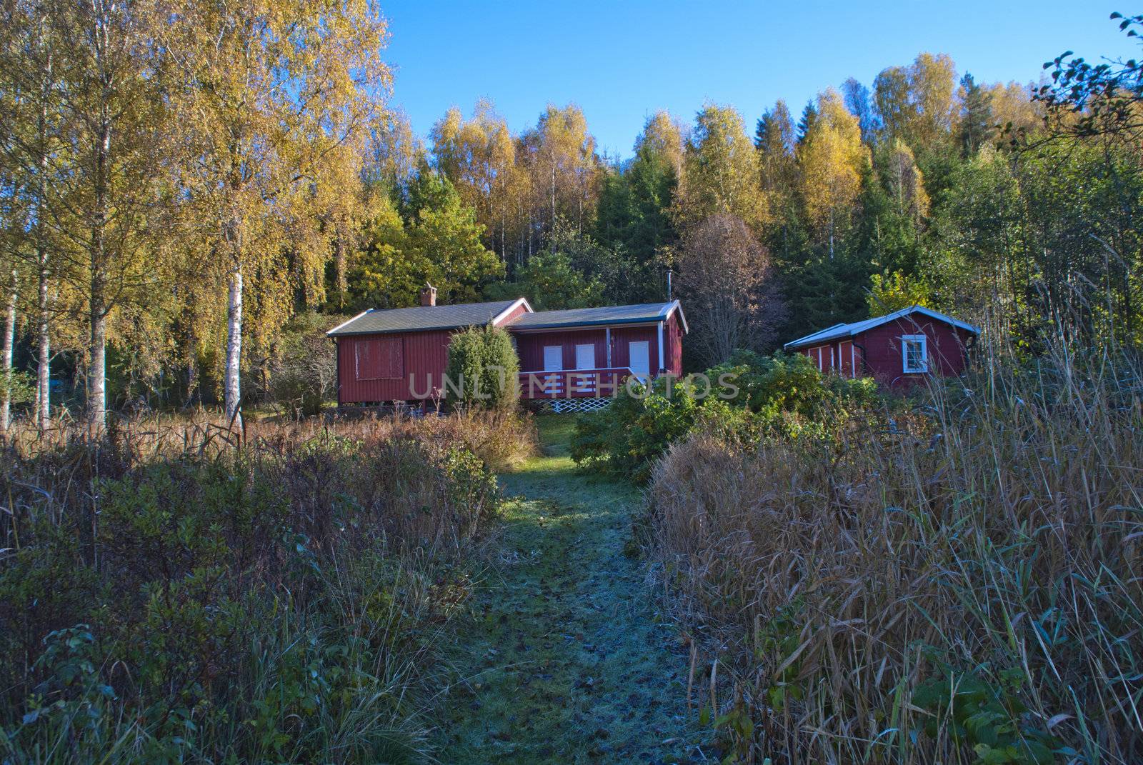 a cozy little red cabin situated close to the  iddefjord at bakke in halden municipality, the cabin has its own small beach 20 meters from the cabin wall, picture is shot in october 2012
