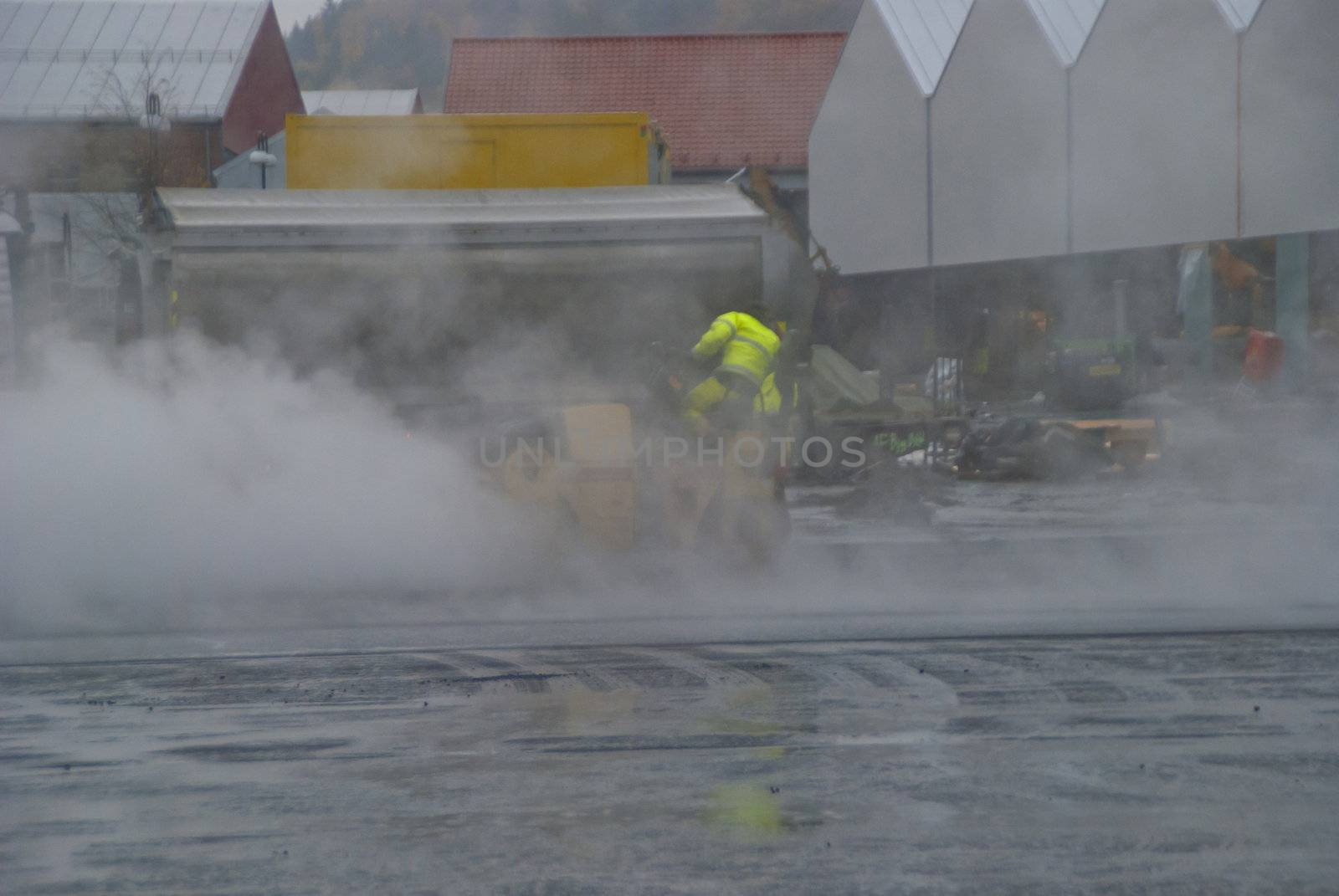 Close to Tista shopping center in Halden is it currently high activity by adding new asphalt on parking spaces, image was shot when it rained, so there was a lot of smoke.