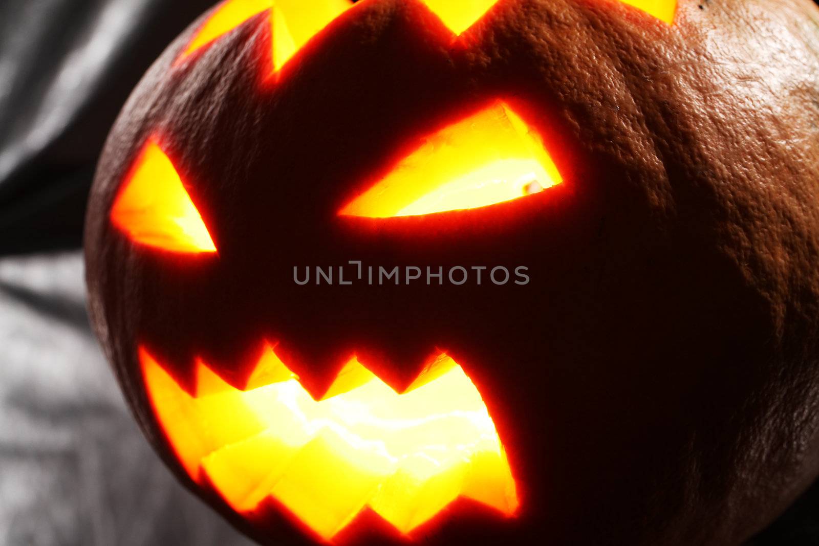 Illuminated halloween pumpkin on a black background
