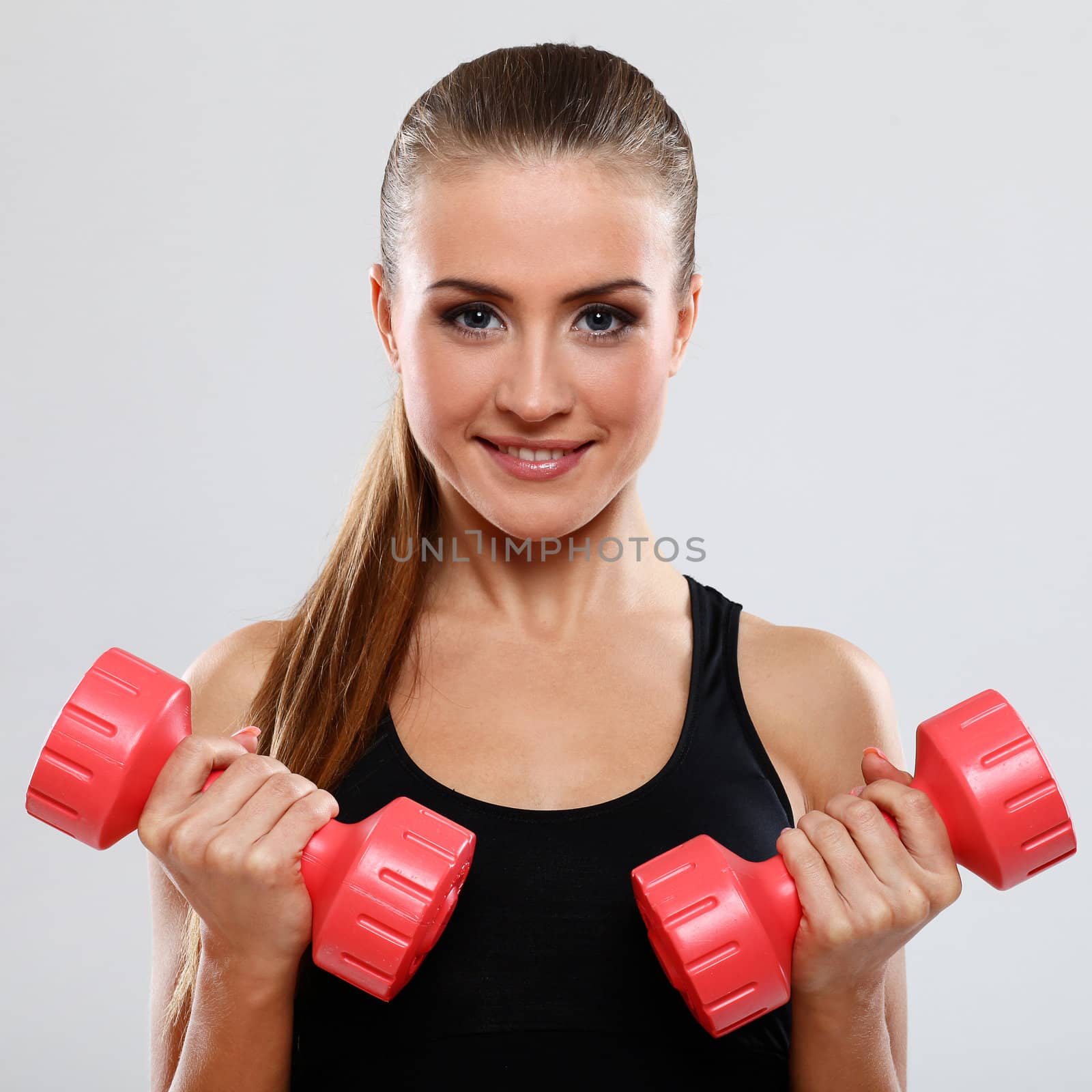 Beautiful brunette working out with dumbbells by rufatjumali