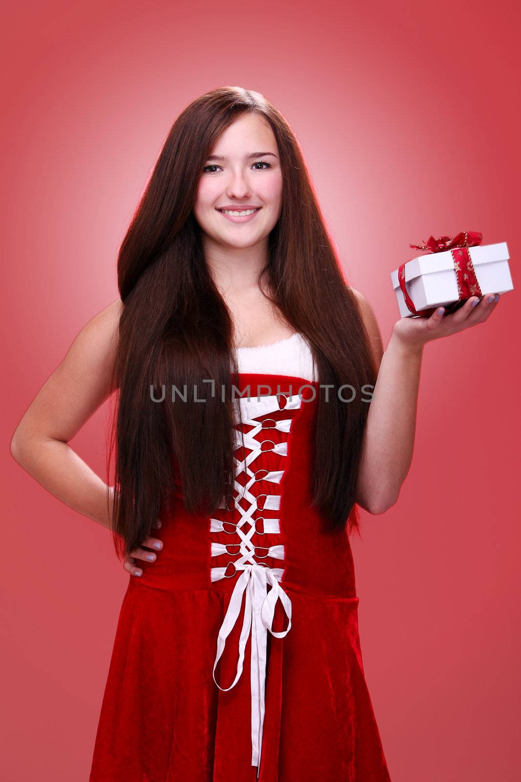 Beautiful christmas girl in red with gift by rufatjumali