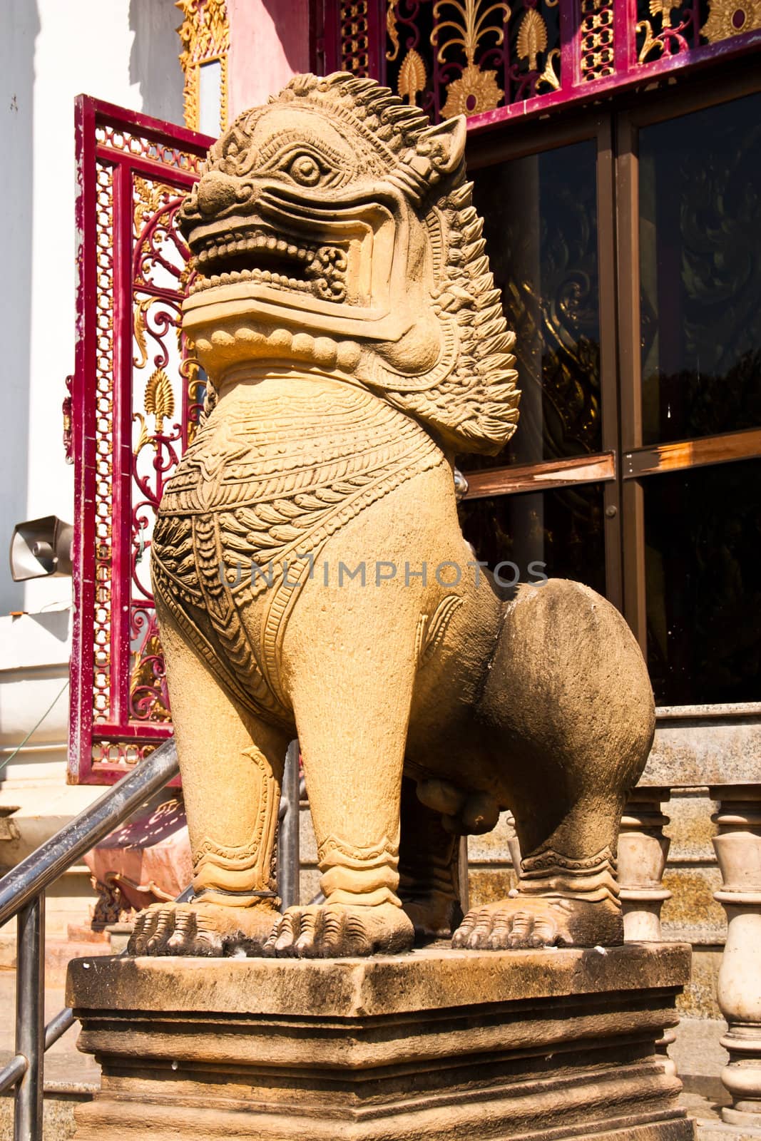The lion statues made ​​of stone. Stand in front of a temple in Thailand at Phetchaburi province.