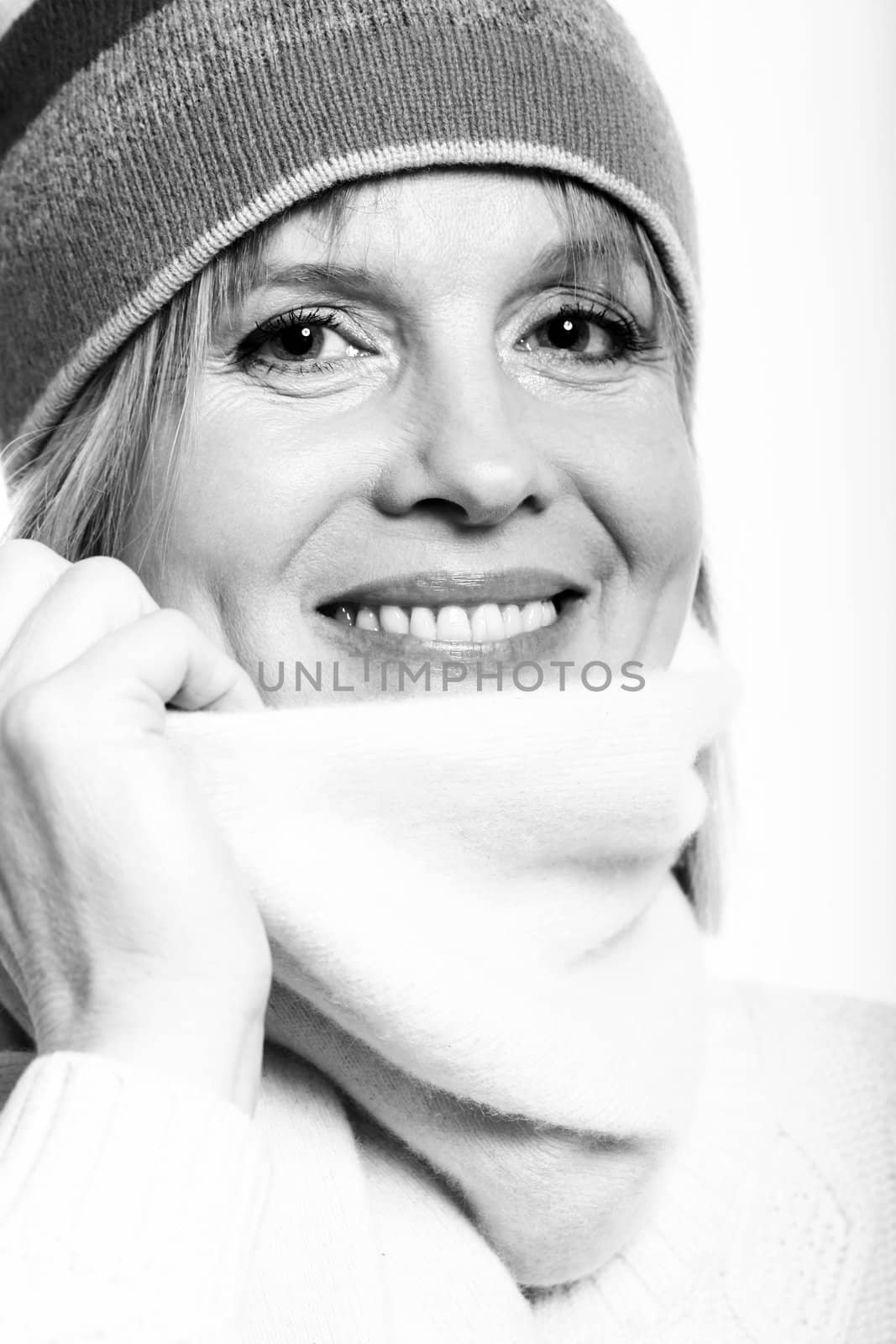 black and white portrait of warm dressed middle aged woman over a white background