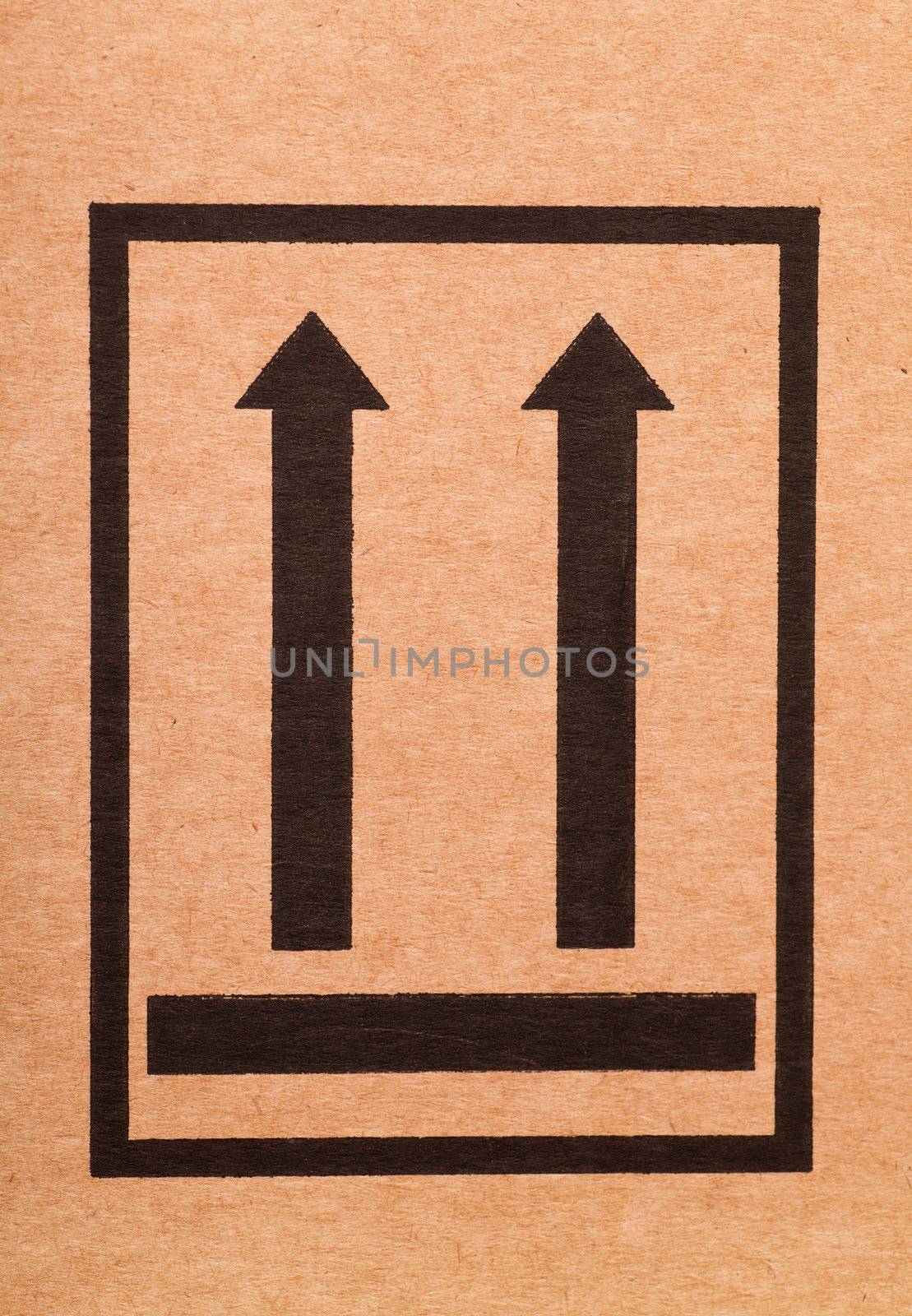 "This side up" sign on a cardboard box
