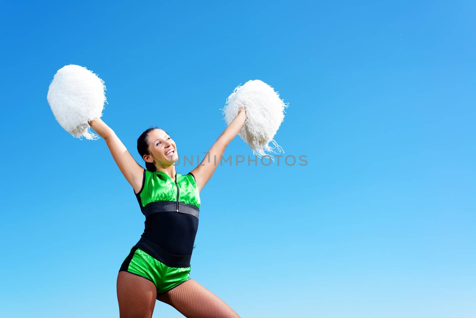 cheerleader girl on a background of blue sky