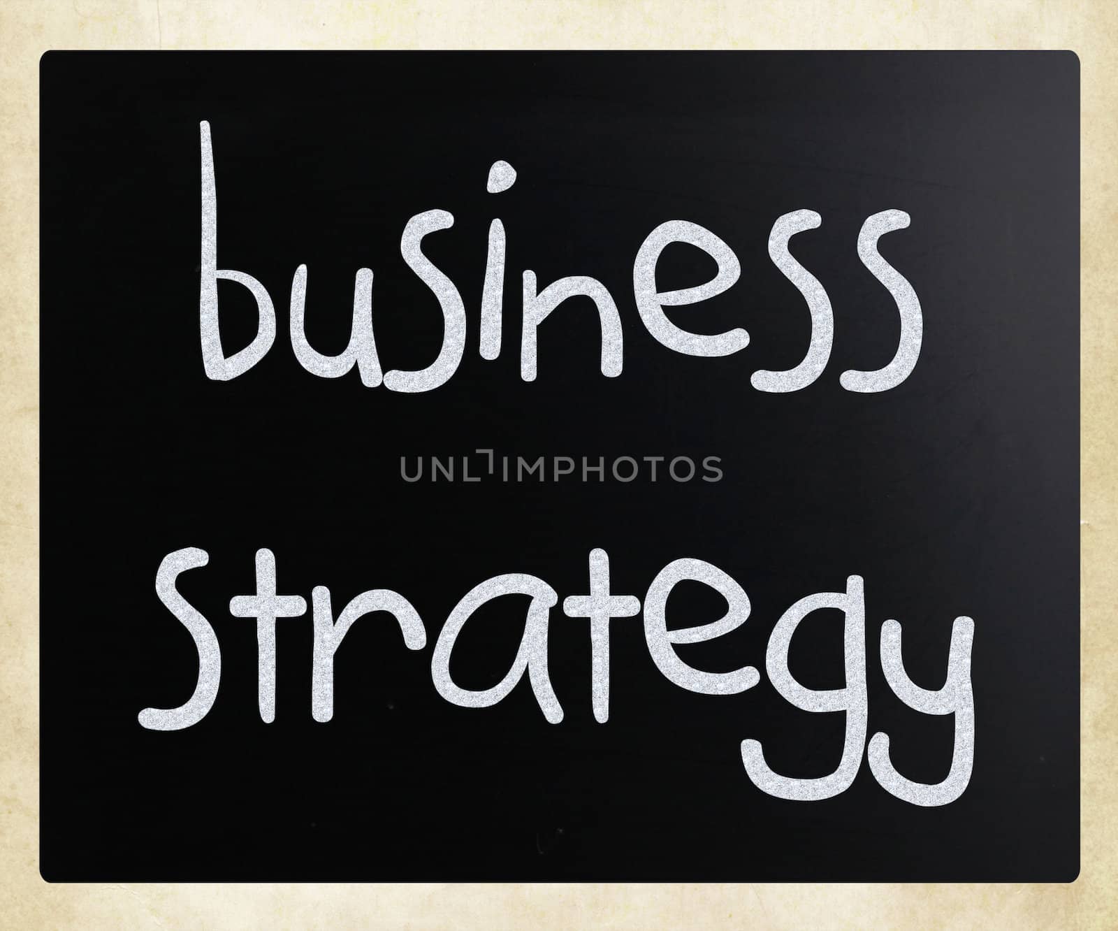 "Business strategy" handwritten with white chalk on a blackboard by nenov