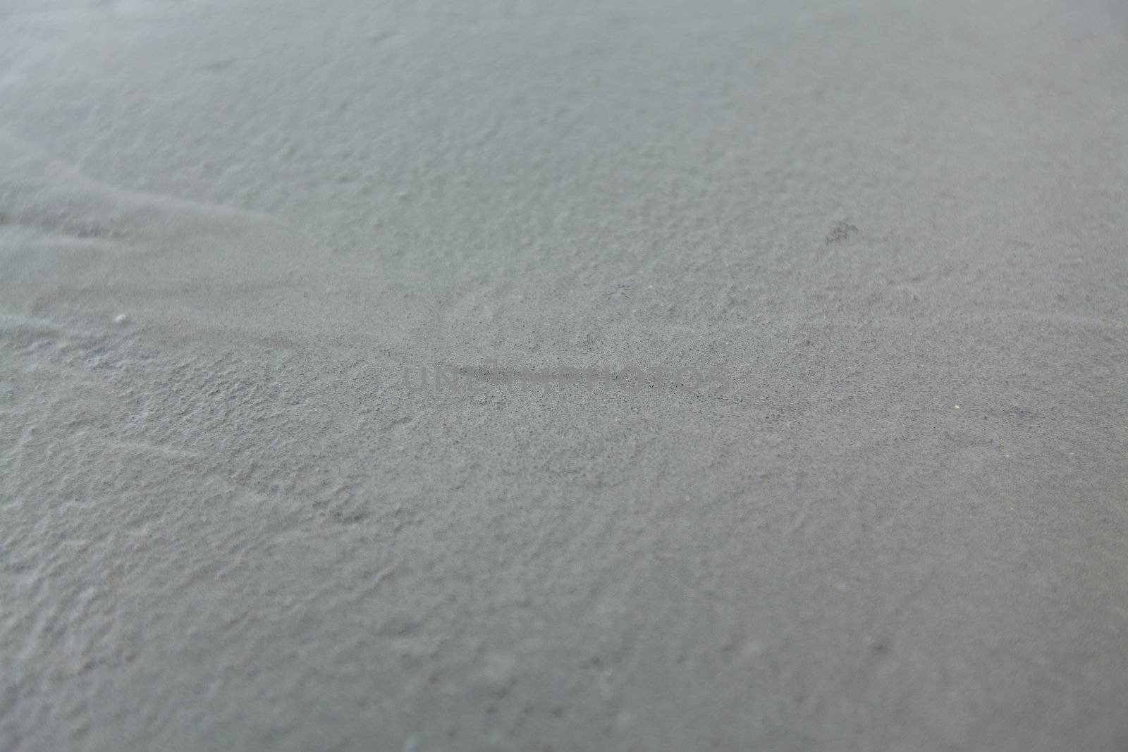 Closeup of a wet concrete. Textured surface