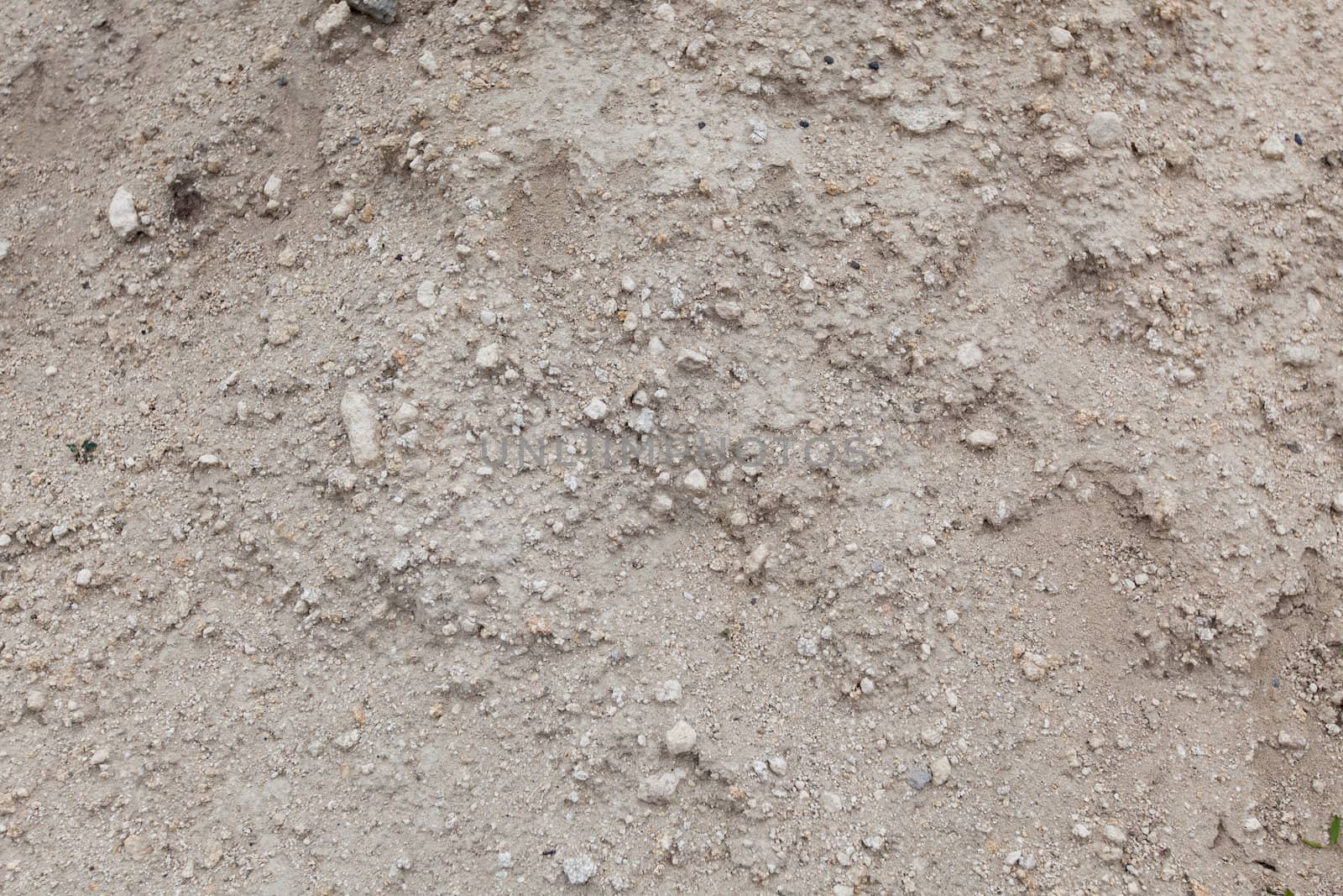 Dry soil with little stones closeup. Textured surface