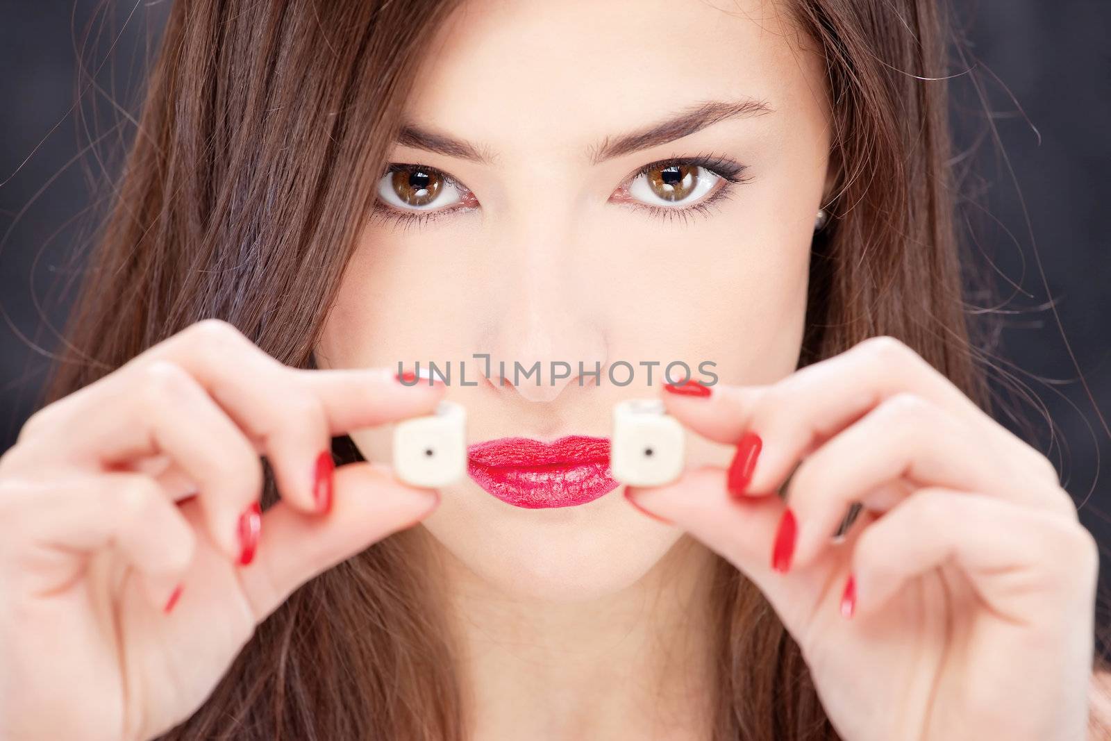 Close up of a young woman holding dices
