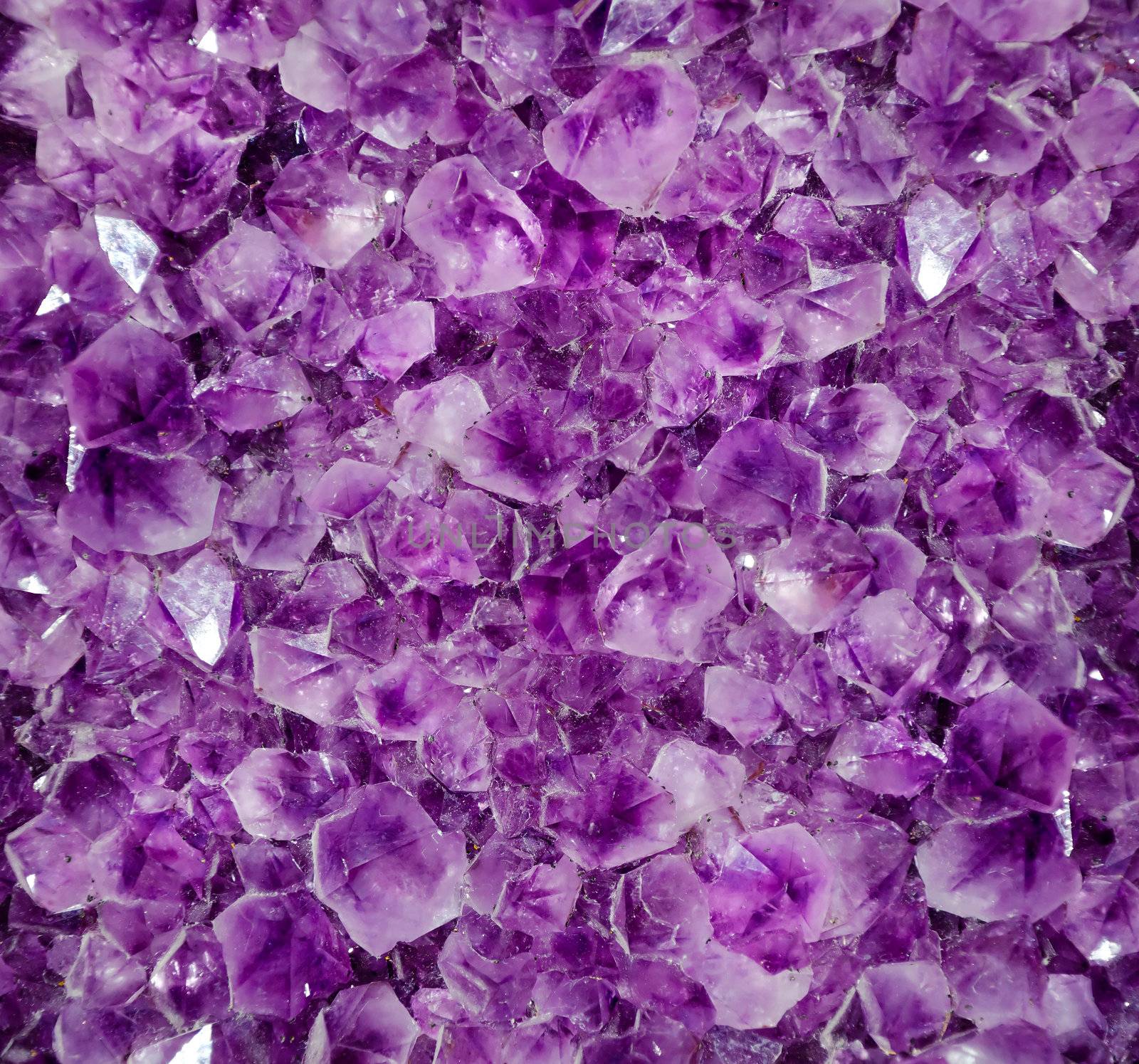 Natural amethyst crystal background. Amethyst is a violet variety of quartz
