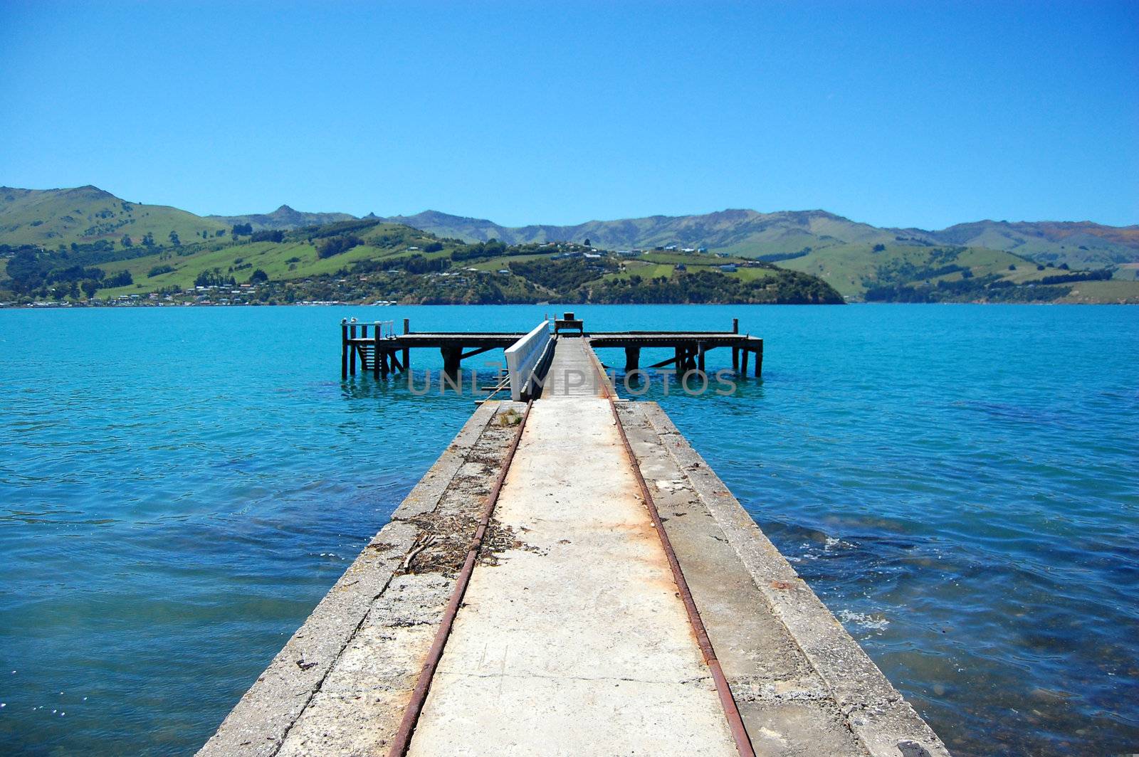 Old concrete pier with rails, Banks Peninsula, New Zealand