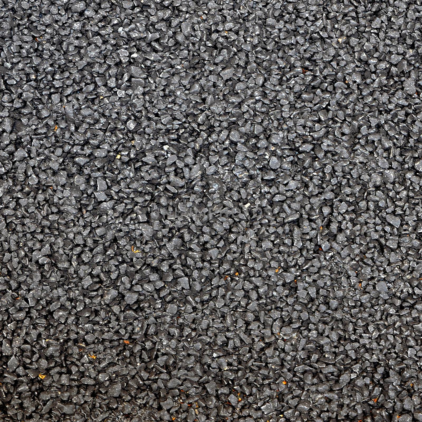 Closeup of the black tar surface of an asphalt road by siraanamwong