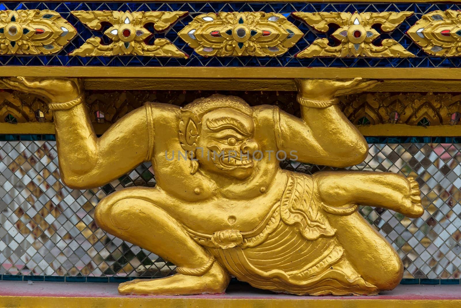 Asian golden demon statue in a sitting position