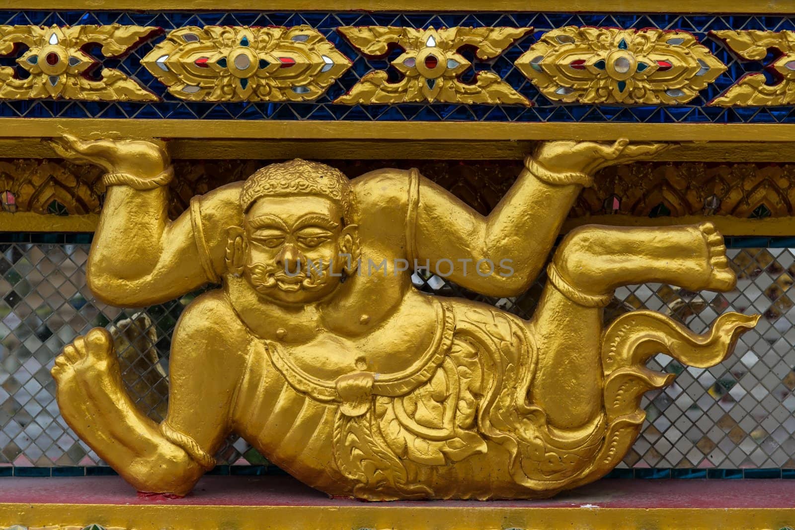 Asian golden demon statue in a sitting position by sasilsolutions