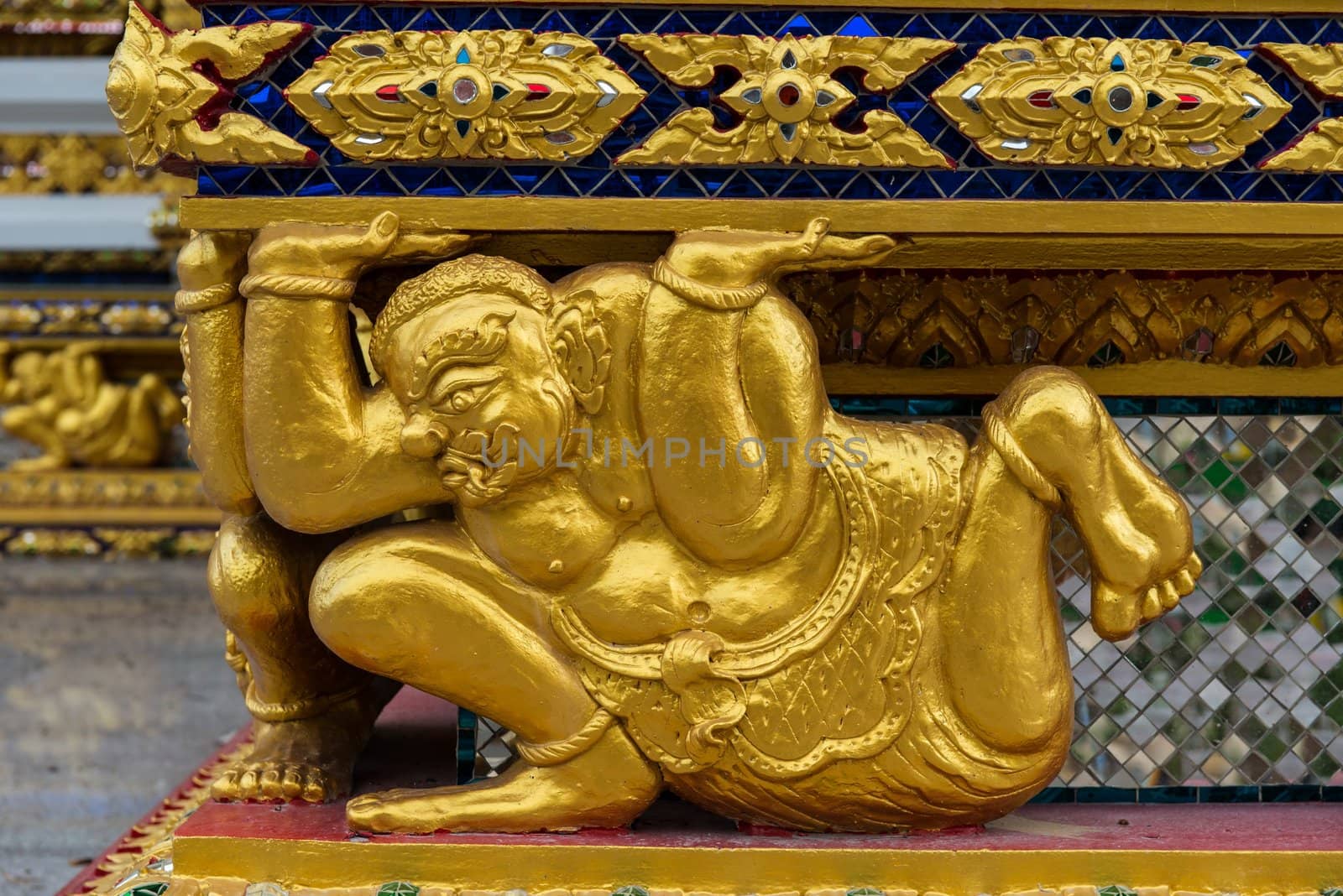 Asian golden demon statue in a sitting position by sasilsolutions