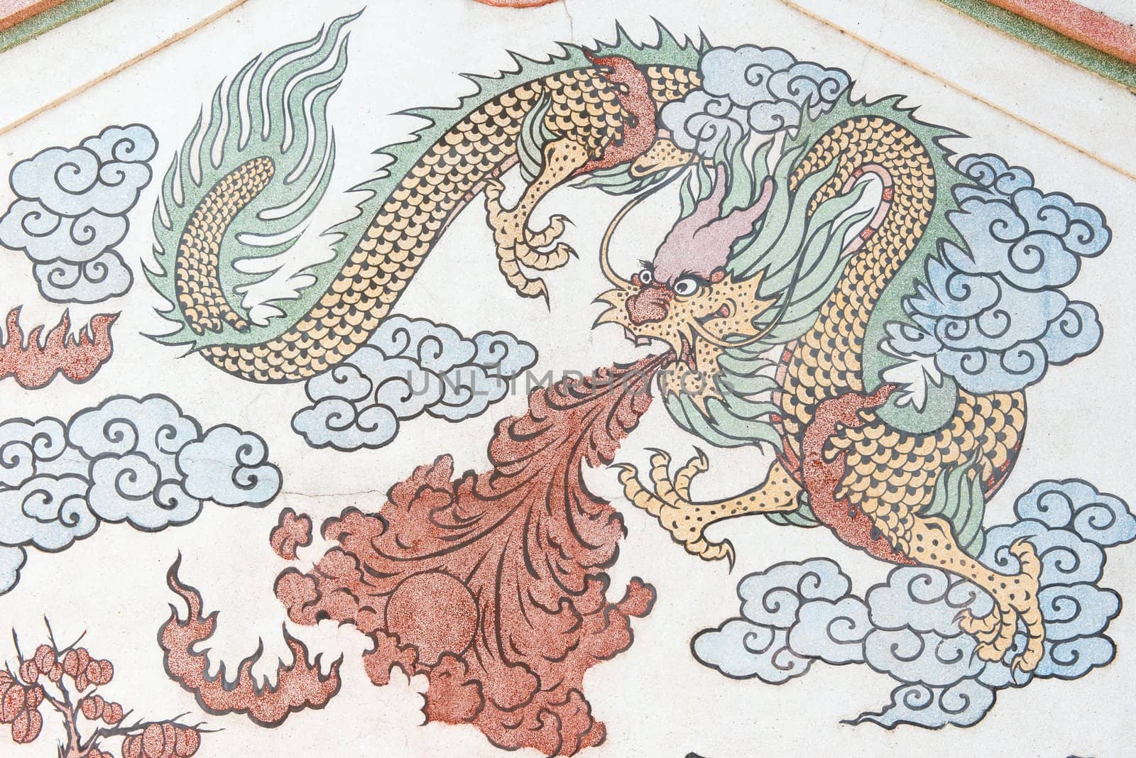 Chinese dragon picture drawing on temple wall taken on a sunny day
