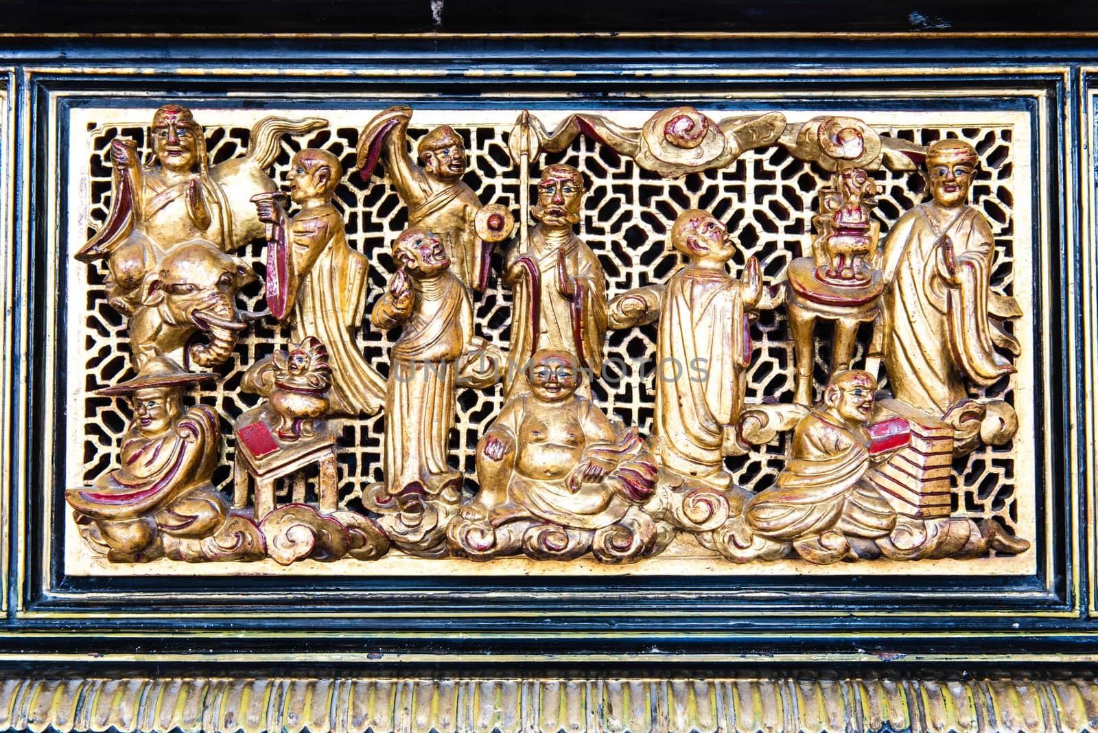 Ancient golden Chinese temple scuplture with symbolic pattern